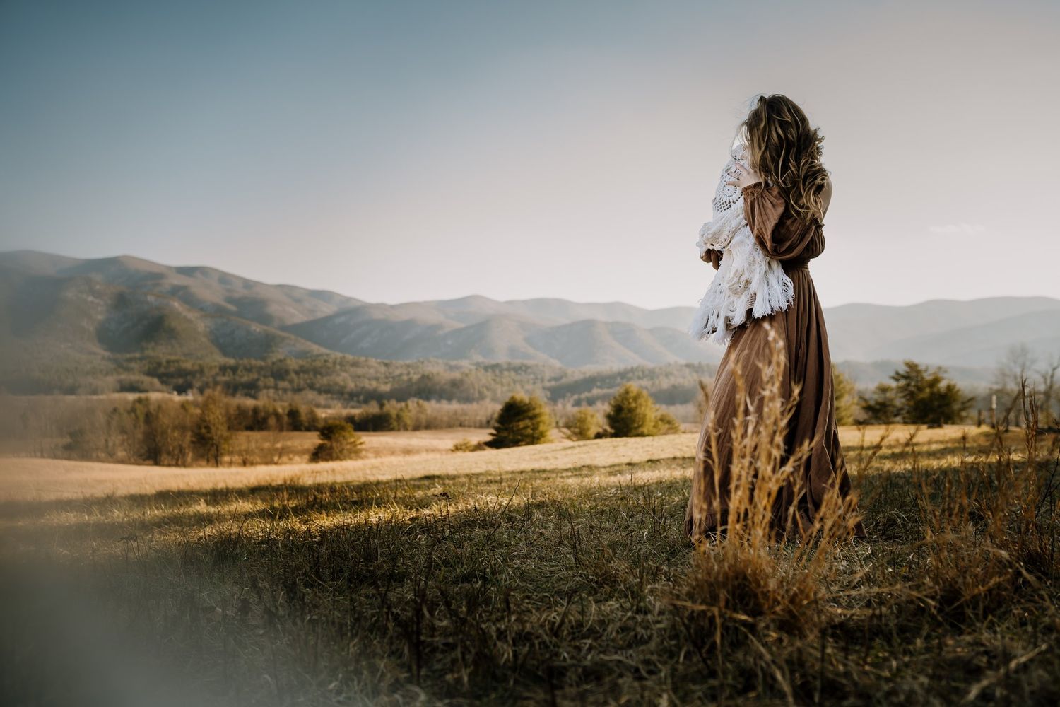 mom holding daughter in cades cove poses for pictures