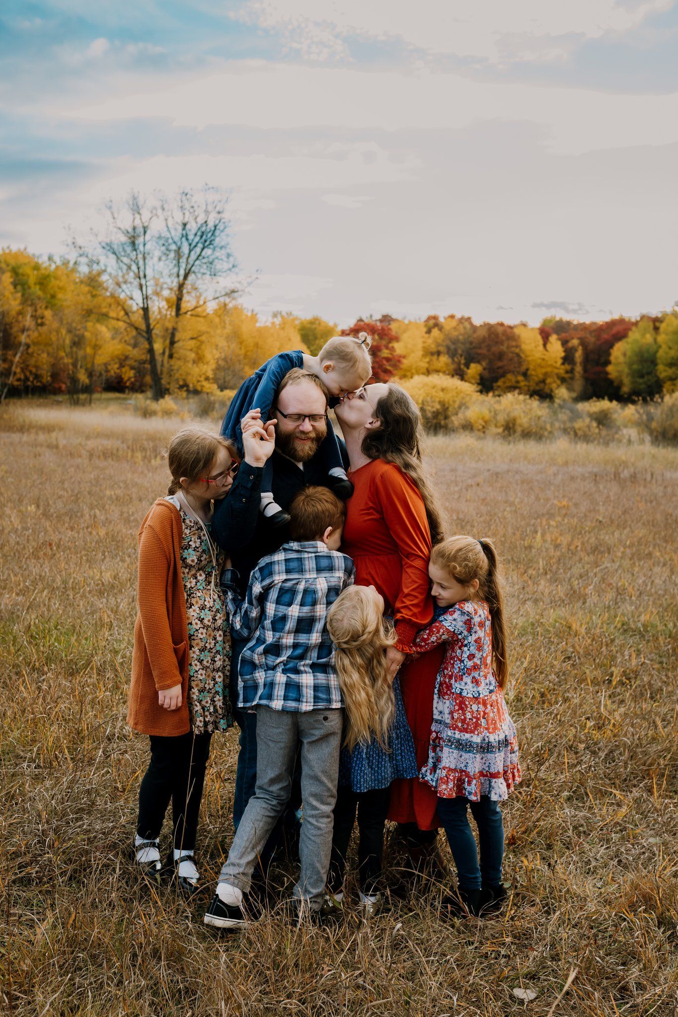 Large family hugs together during outdoor lifestyle family photos