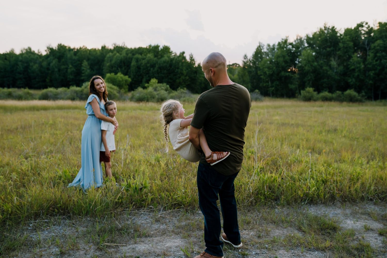 Family plays together in a field