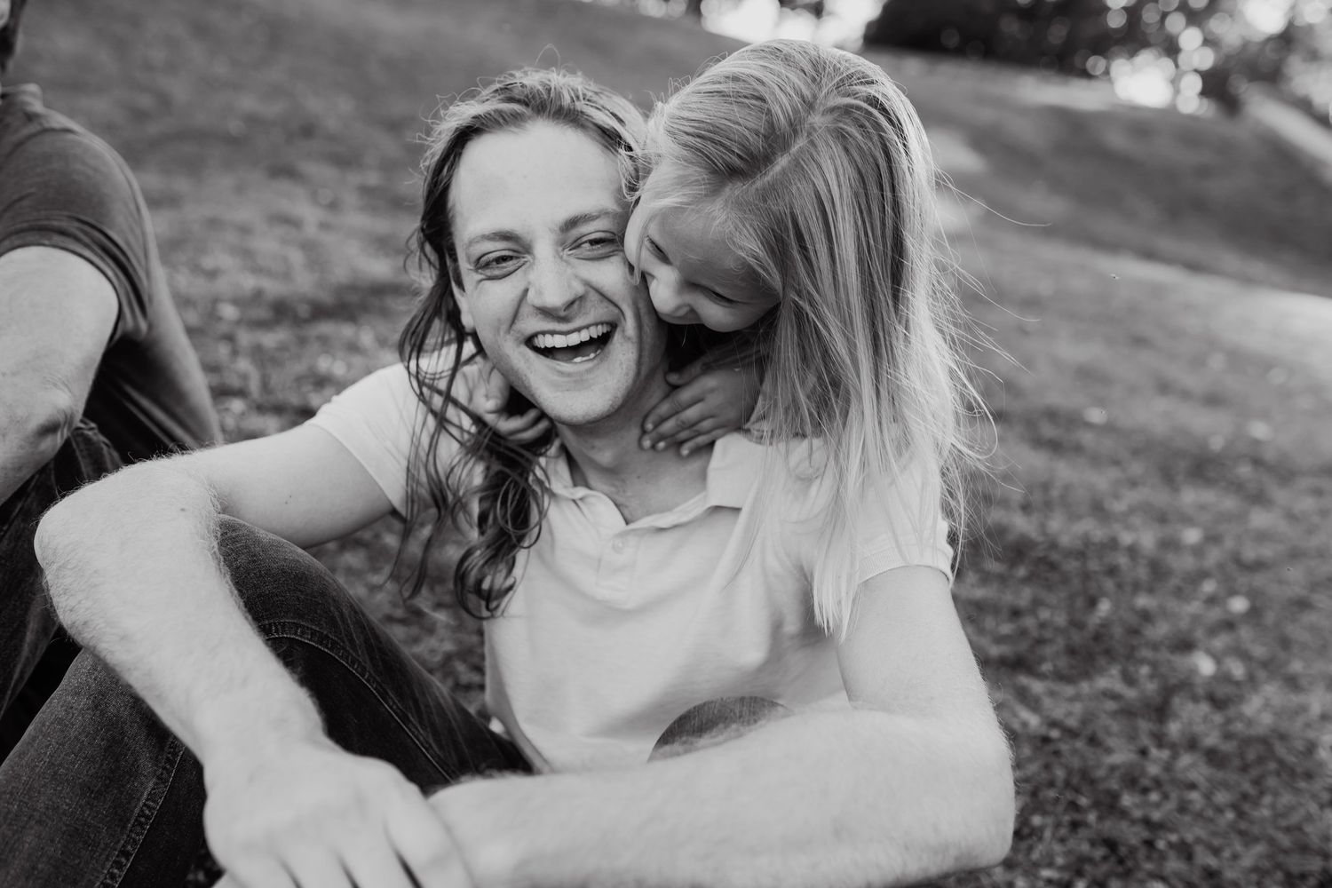 Little girl embraces her uncle and he laughs