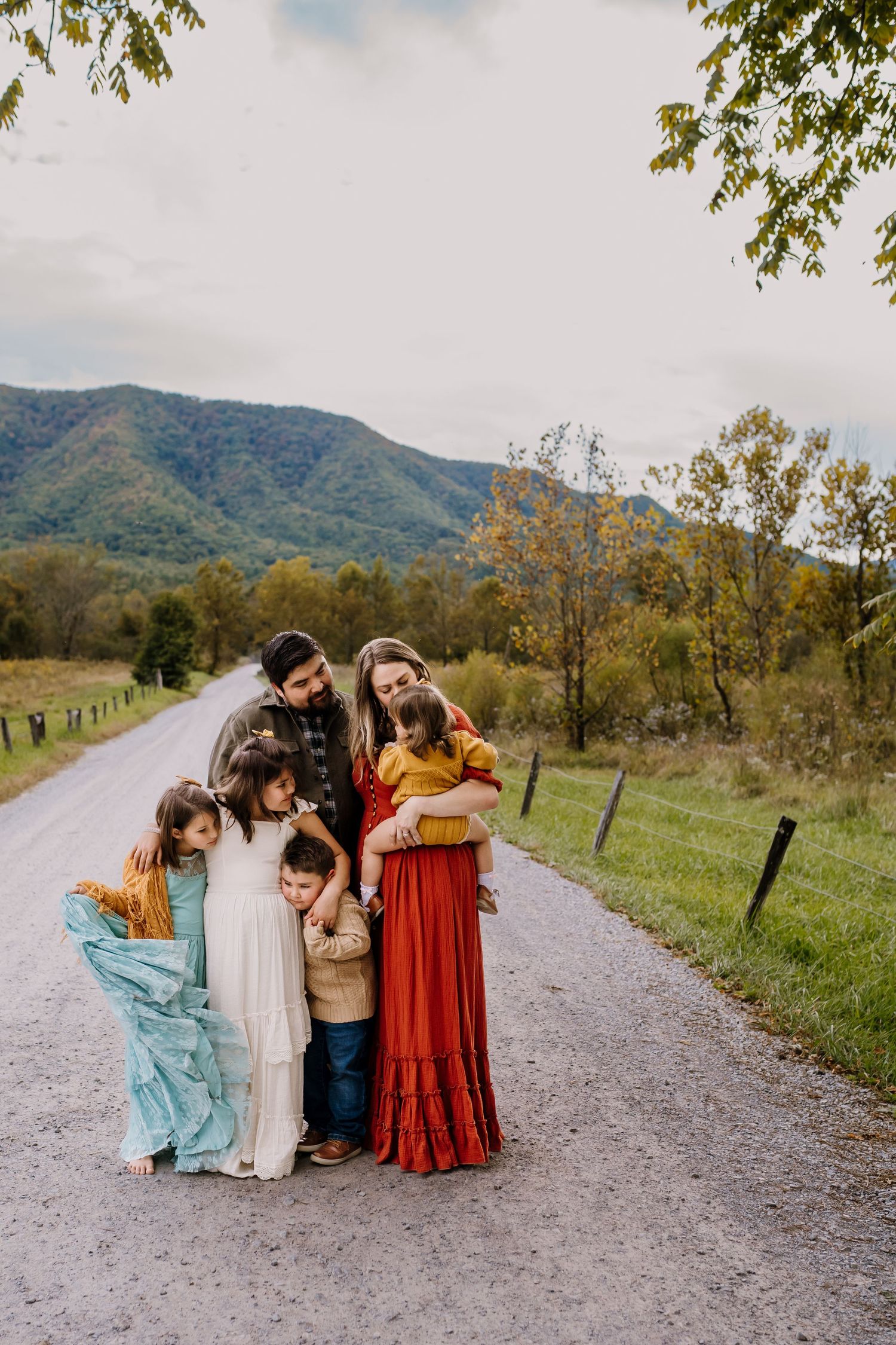 Family stands on Sparks Lane and snuggles together