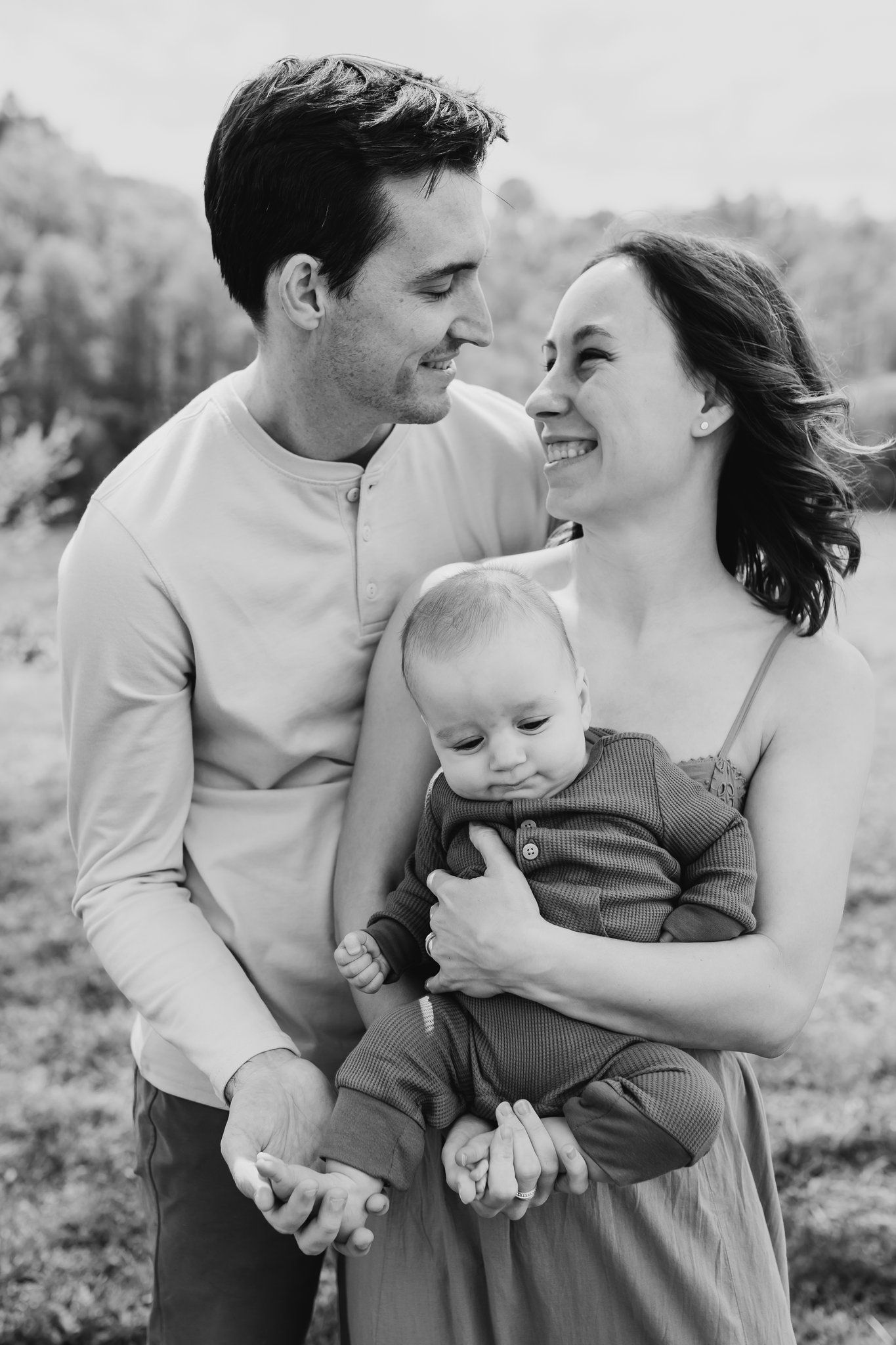 Family of three smiles together happily in Sequoya Hills