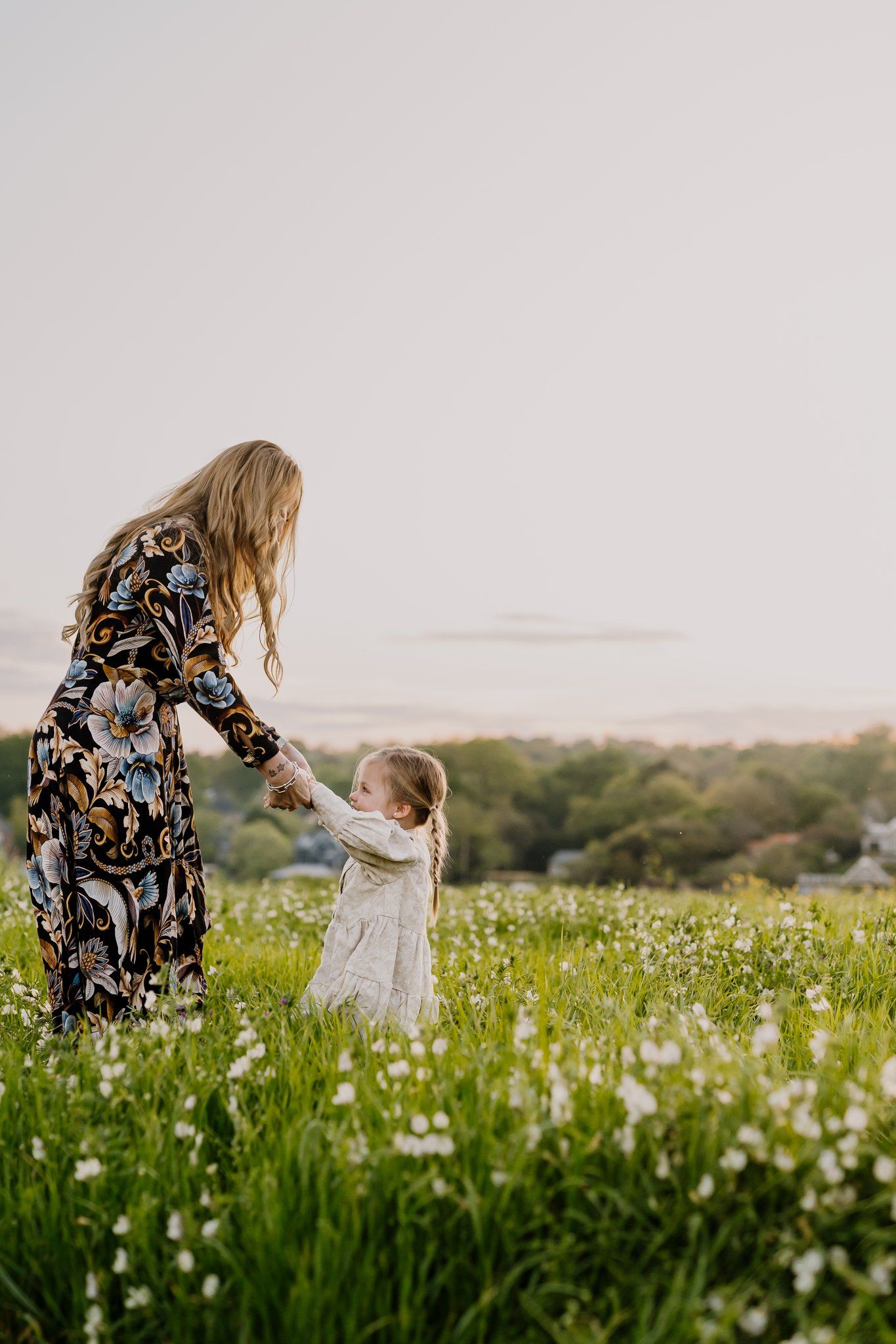 Mom dances with her toddler in a field of flowers in knoxville tn