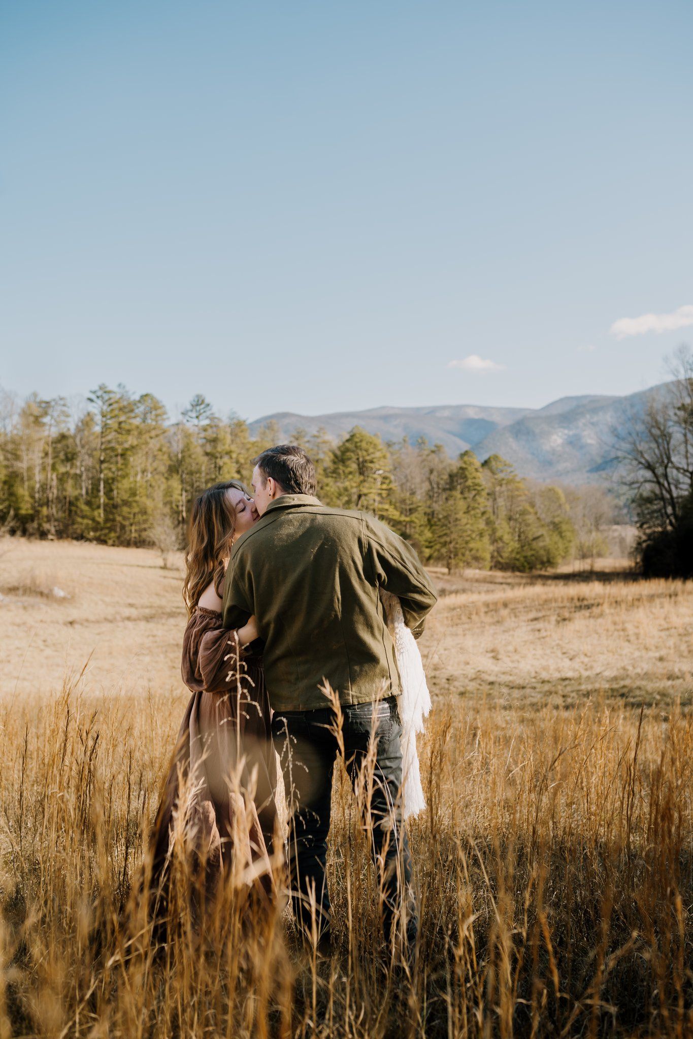 family in cades cove poses for pictures