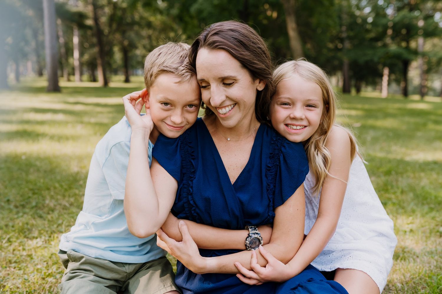 Mom embraced by her children during family portraits