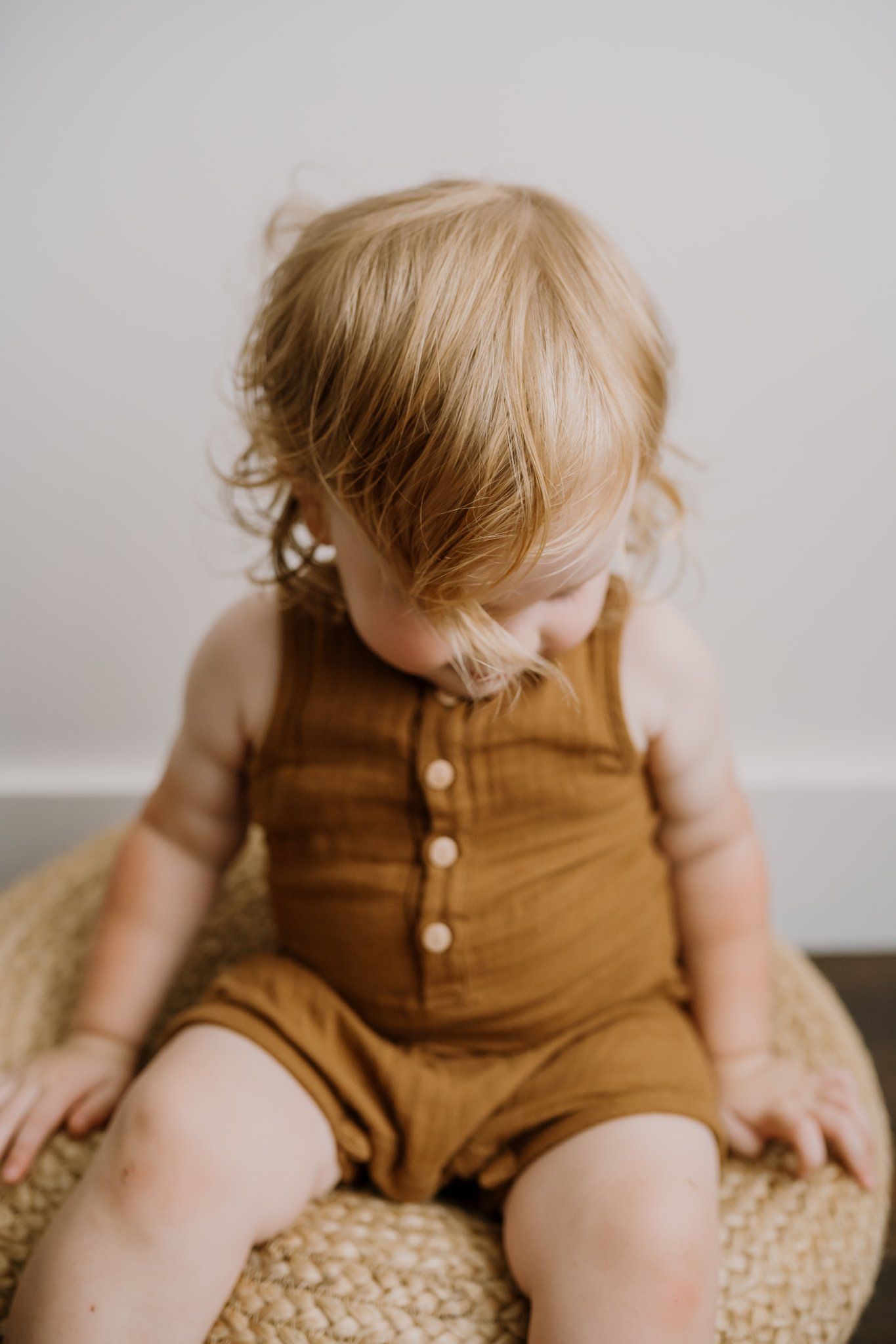child sits on bean bag for studio personality photos