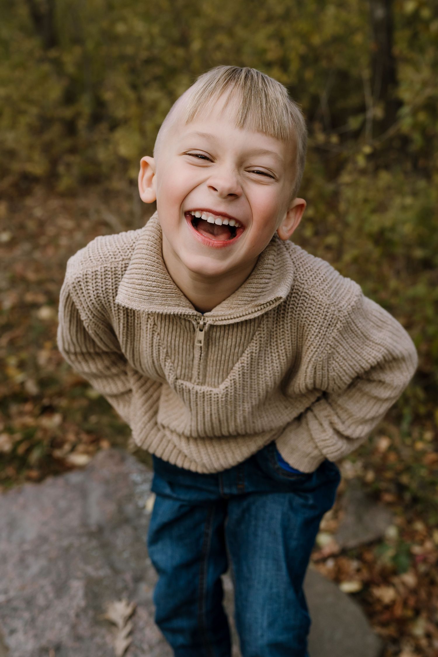 portrait of a child laughing at the camera during lifestyle family pictures with photographer St. Cloud minnesota
