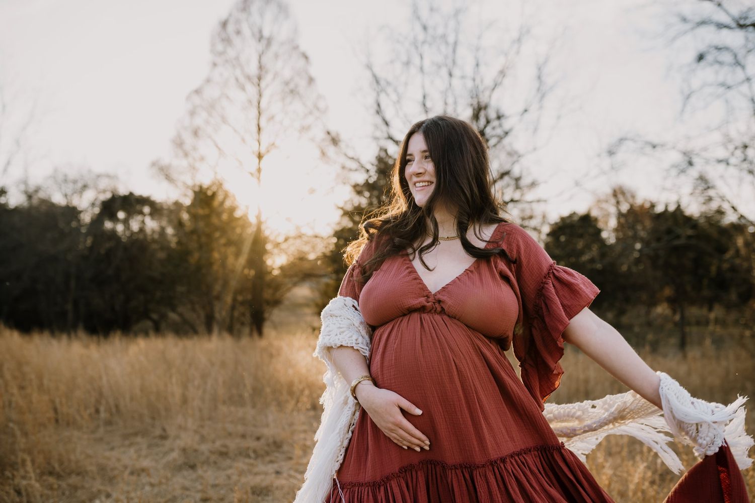 Pregnant woman holds her belly during maternity photos in east tennessee winter