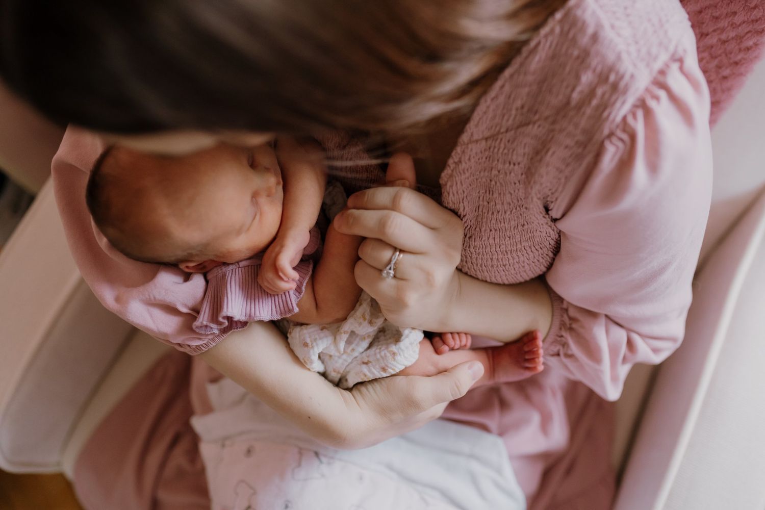 Woman kisses newborn baby