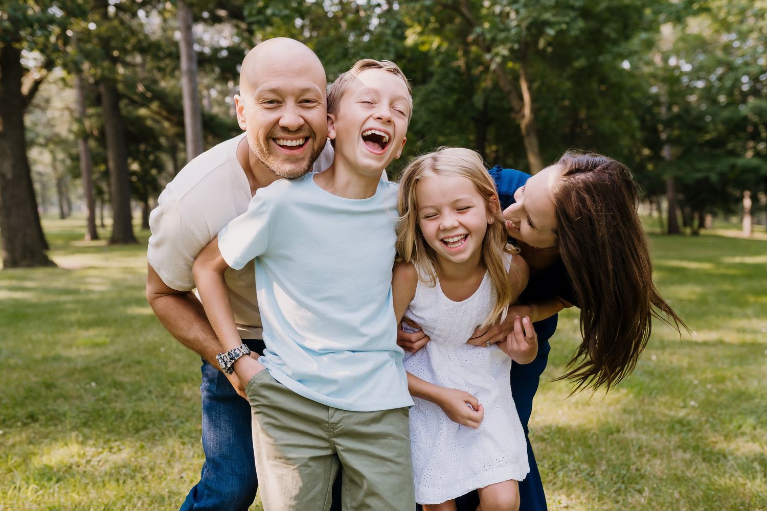 Parents laugh with their children as they surprise them from behind