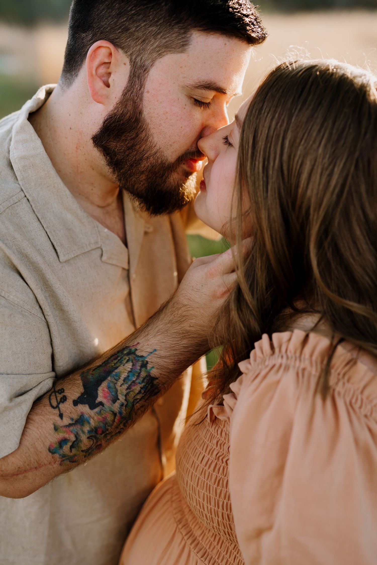 Man kisses woman at golden hour