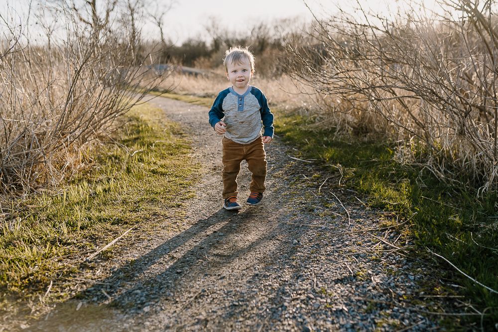 toddler runs down path at Eagle Park in Rockville Minnesota during photoshoot