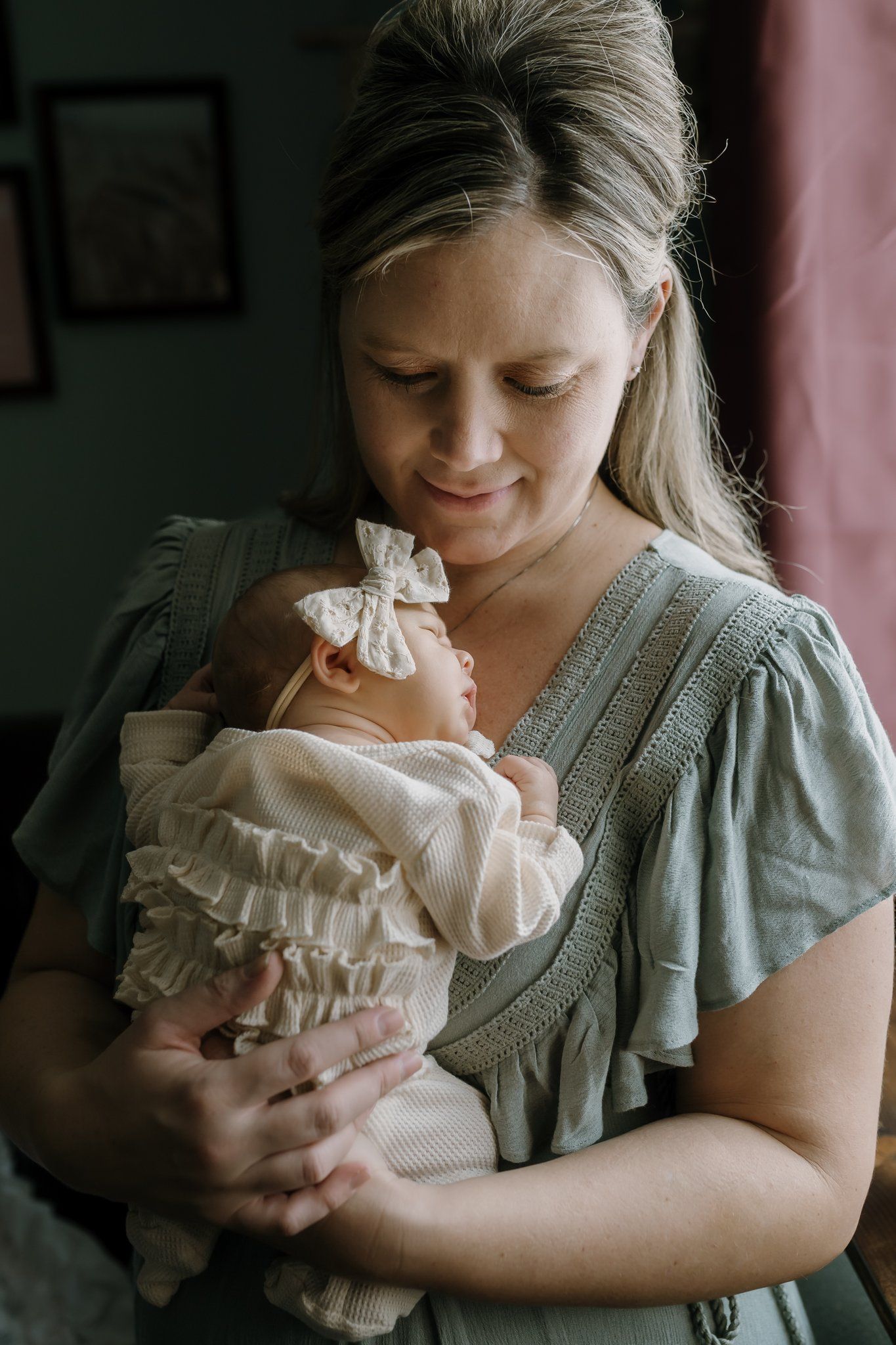 mom cuddling newborn during baby's photoshoot Knoxville in home newborn photos