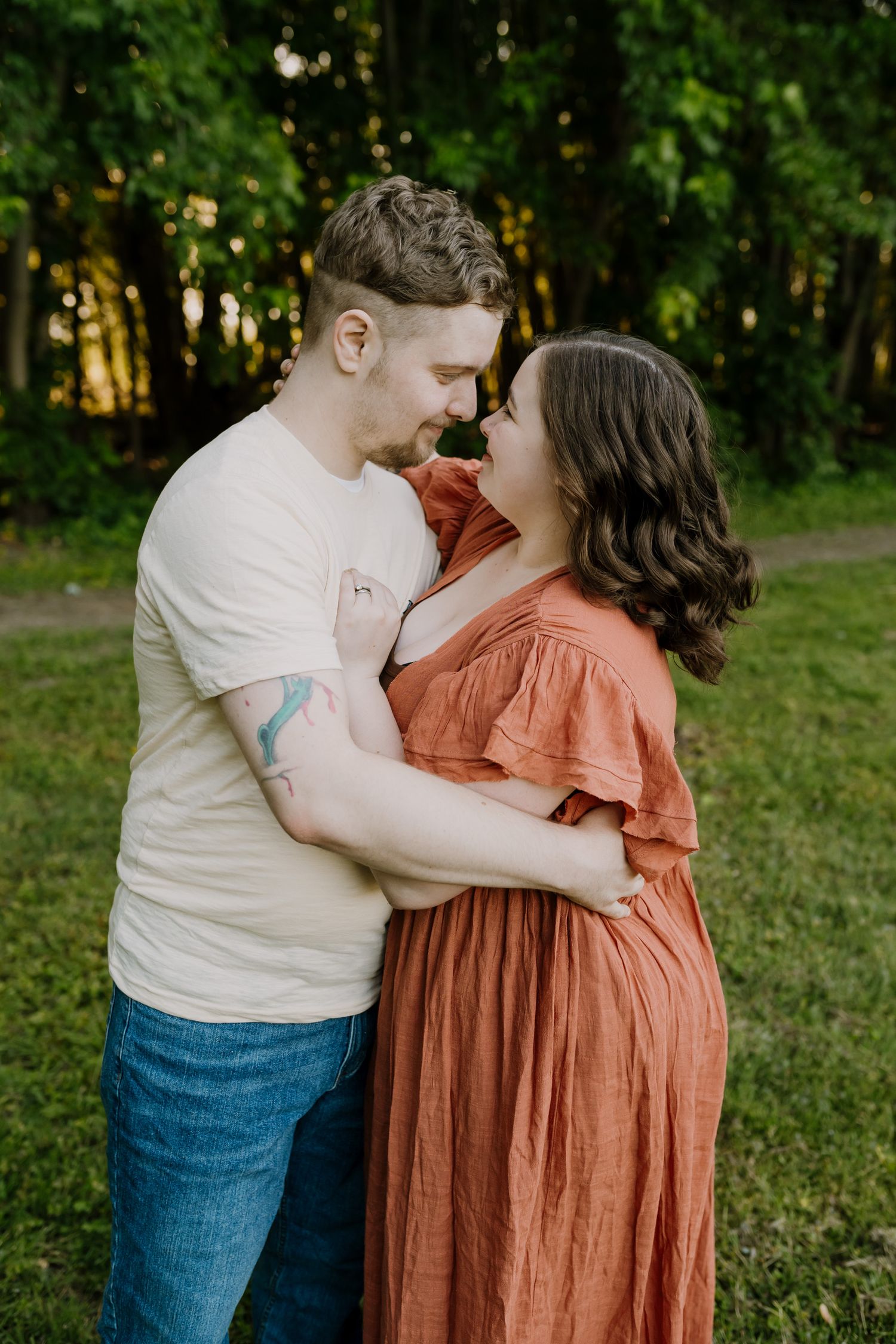 Mom and dad share a moment during family pictures outdoors in the summer
