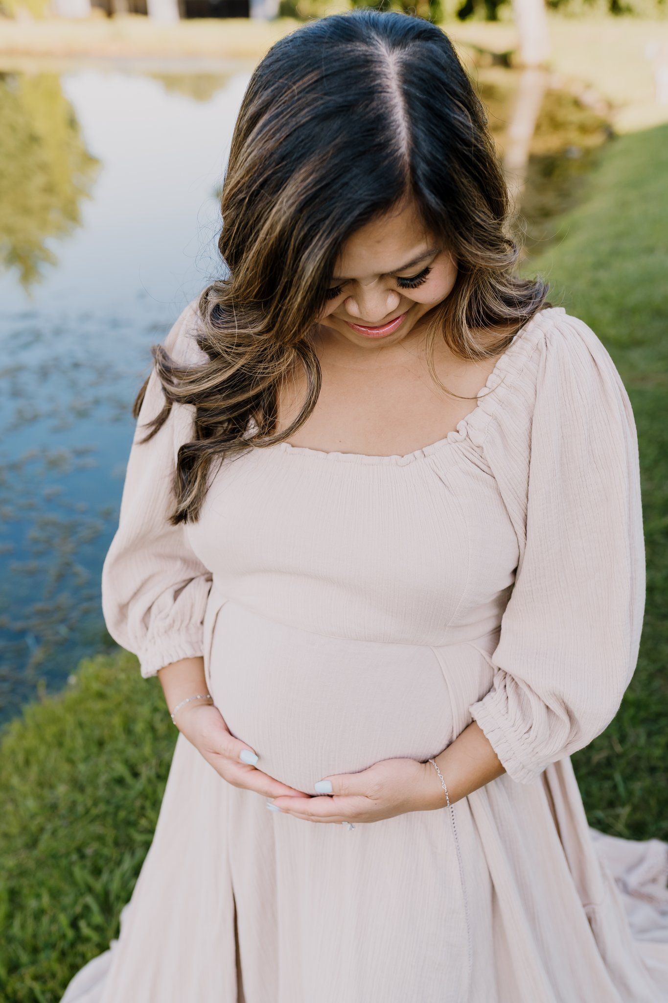 Mom smiles at baby bump during knoxville maternity photographer session