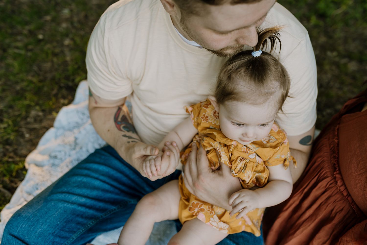Dad holds his daughter's hand