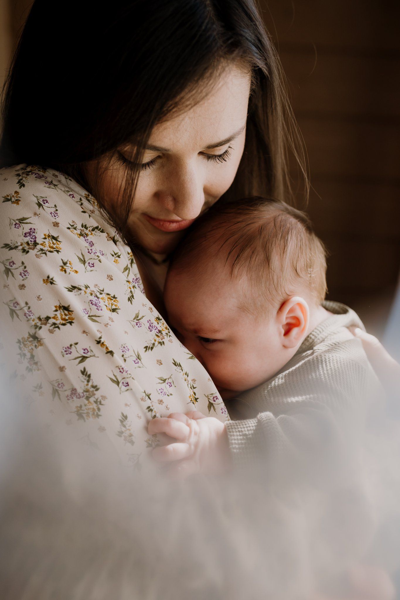 Mom snuggles baby