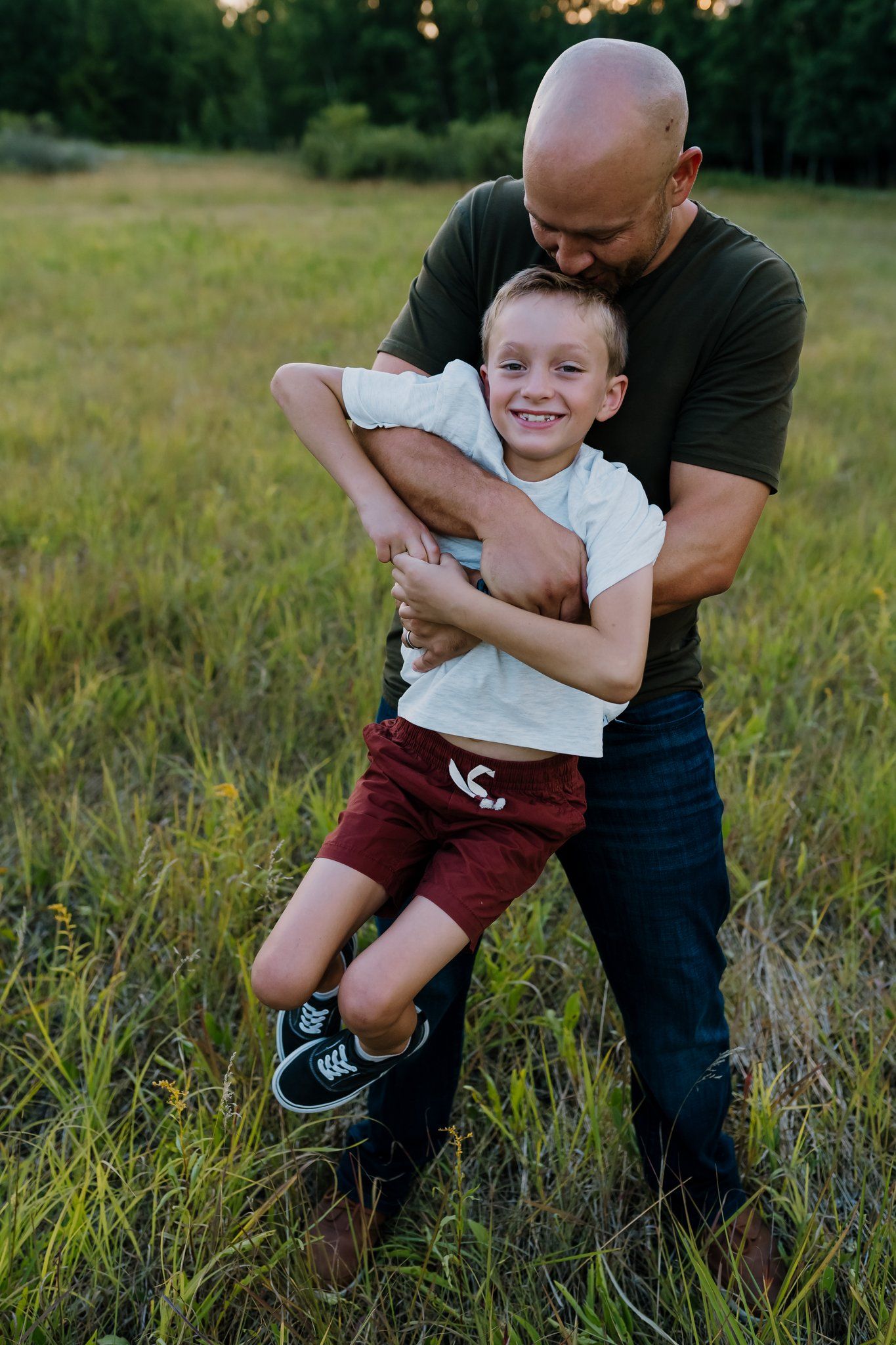 Dad picks up his son and swings him