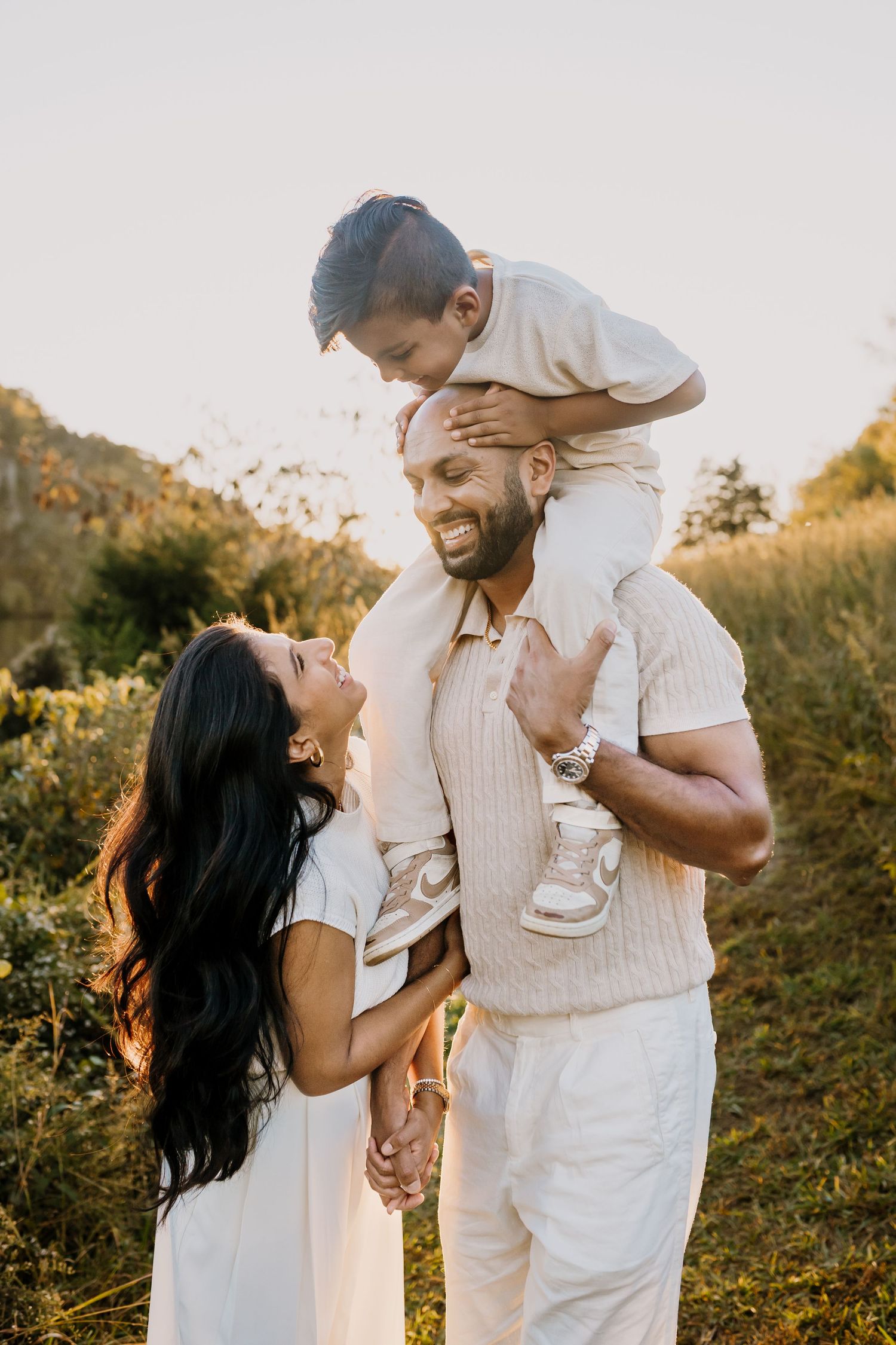 family laughs together during golden hour family photos
