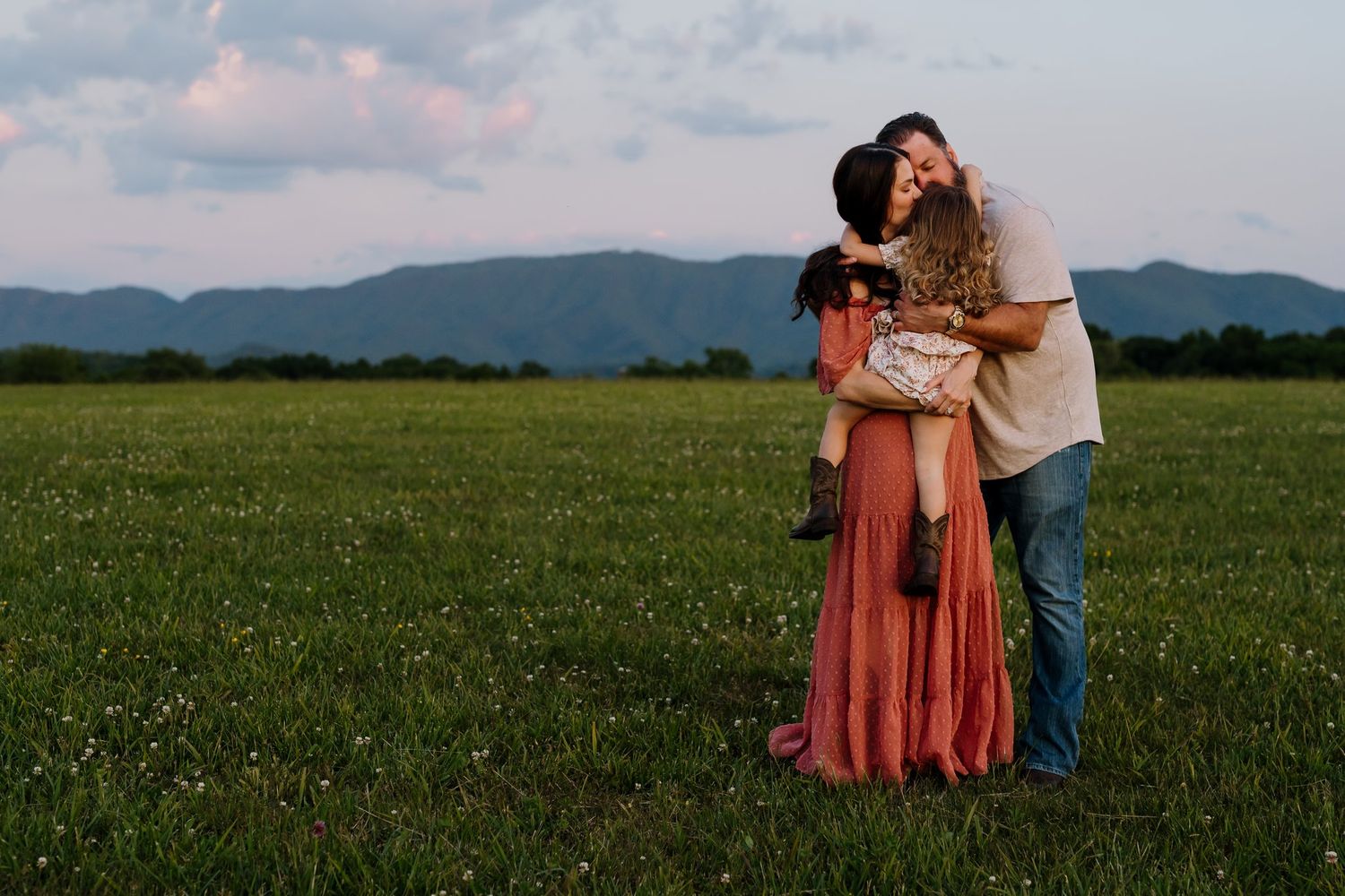 Parents stand in Maryville field for smoky mountain family portraits