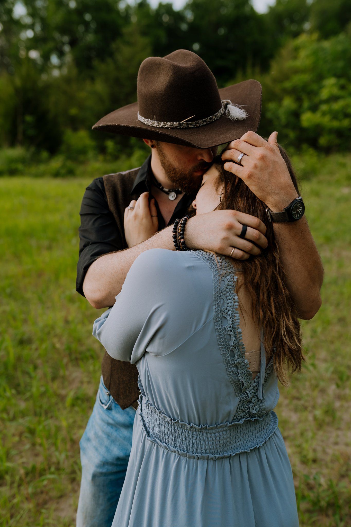 Husband embraces his wife and plays with her hair