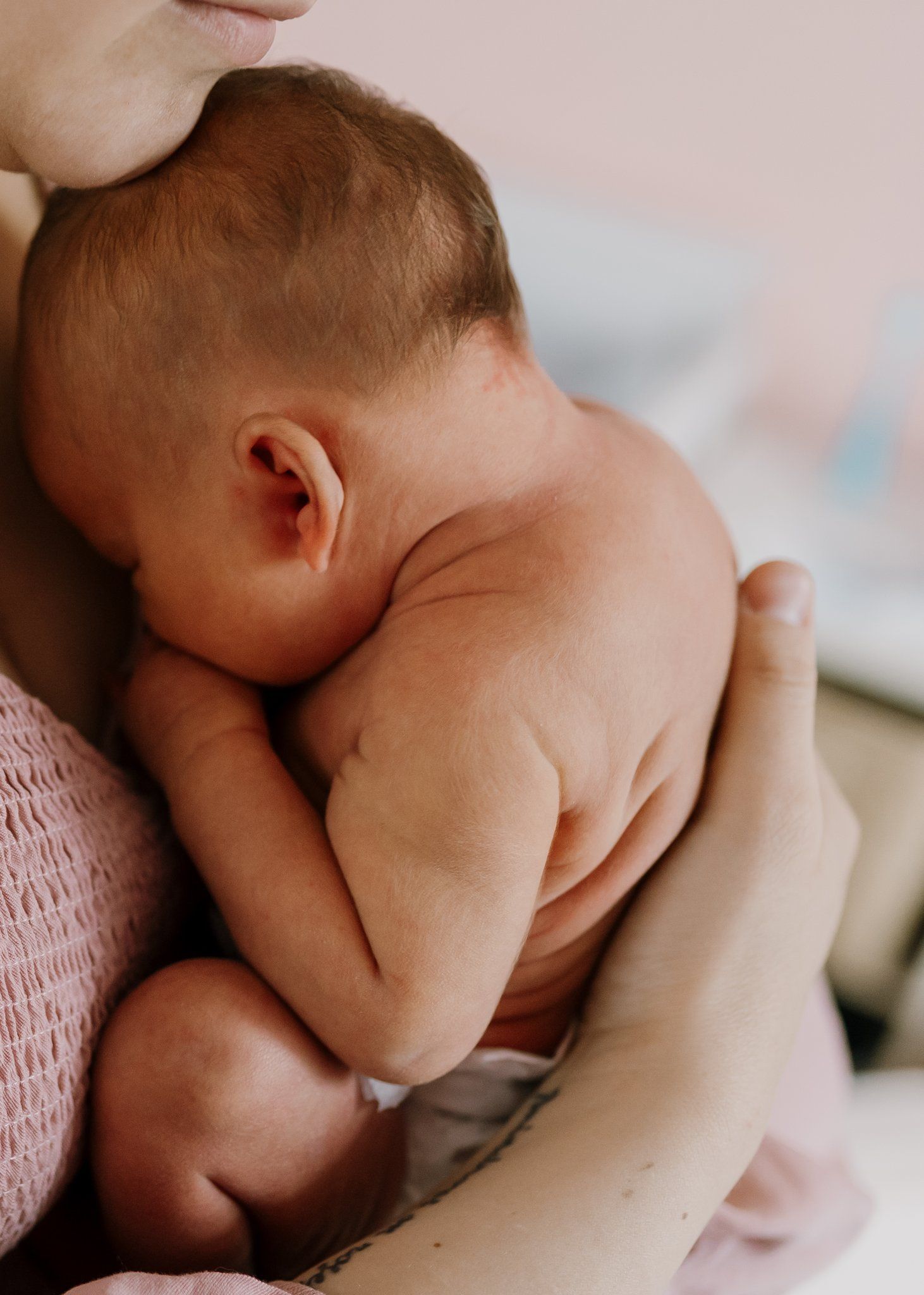 Baby snuggles against mom