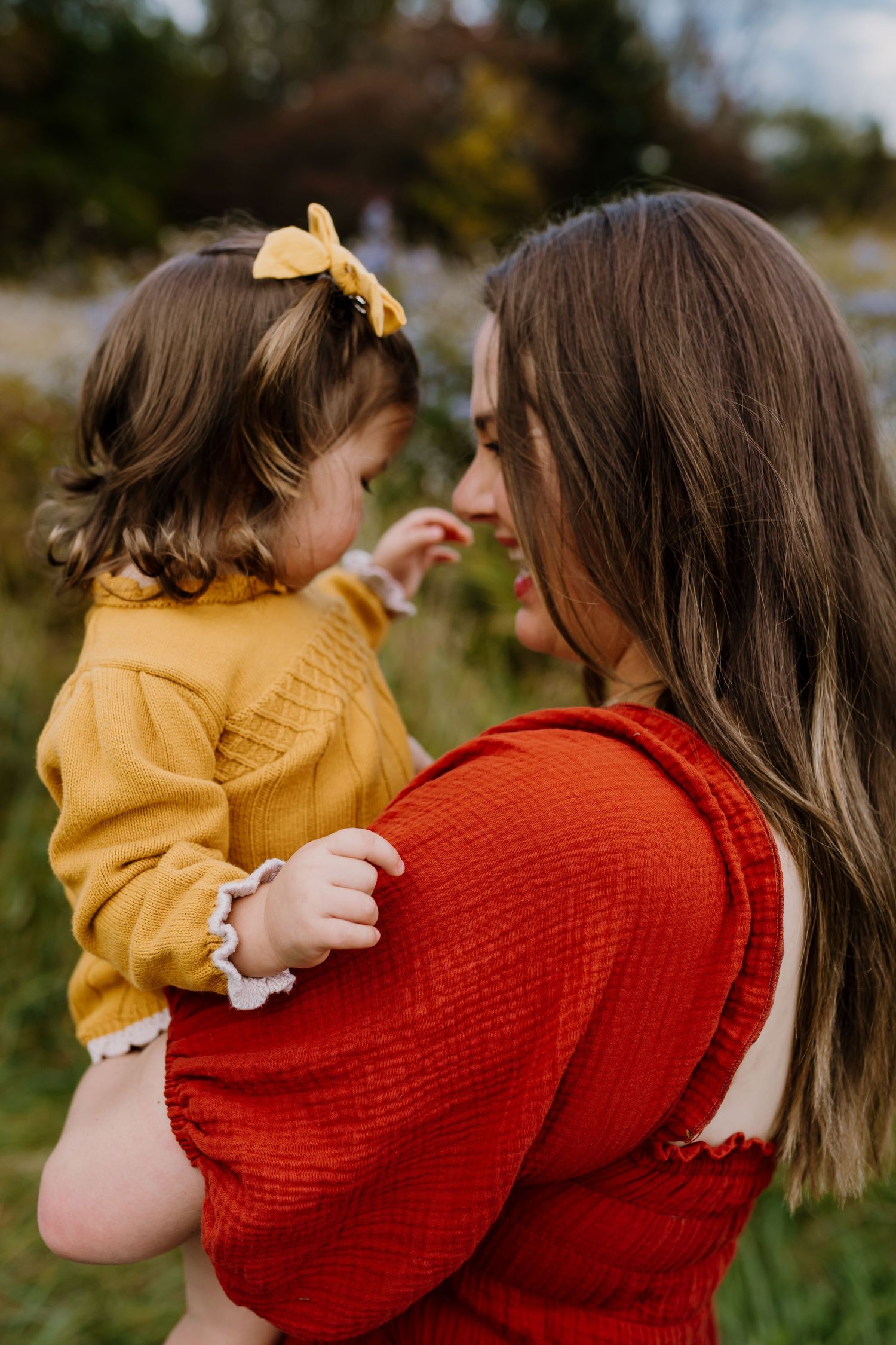 Woman holds toddler and looks at her