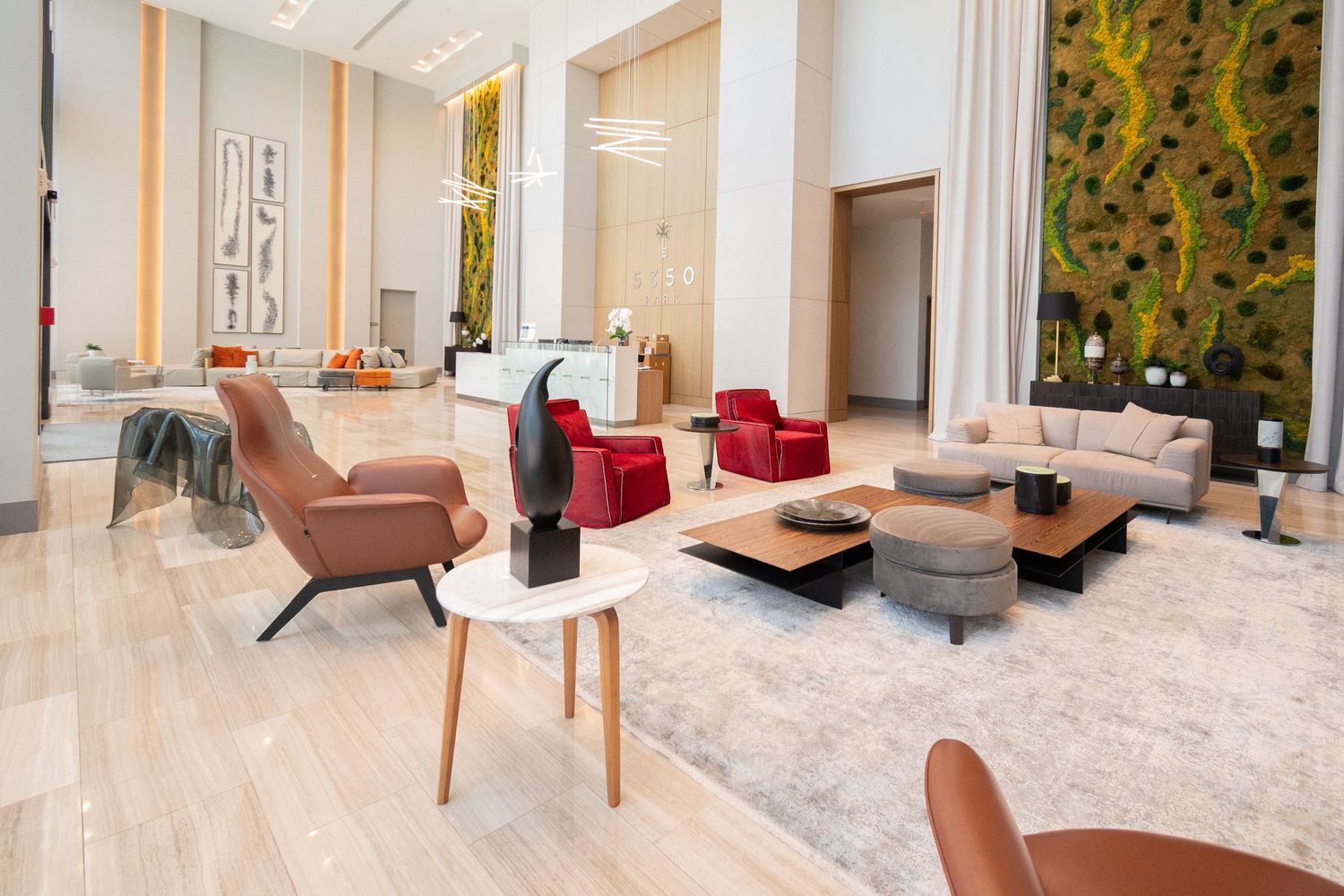 Modern lobby space with comfortable seating and artistic wall feature.