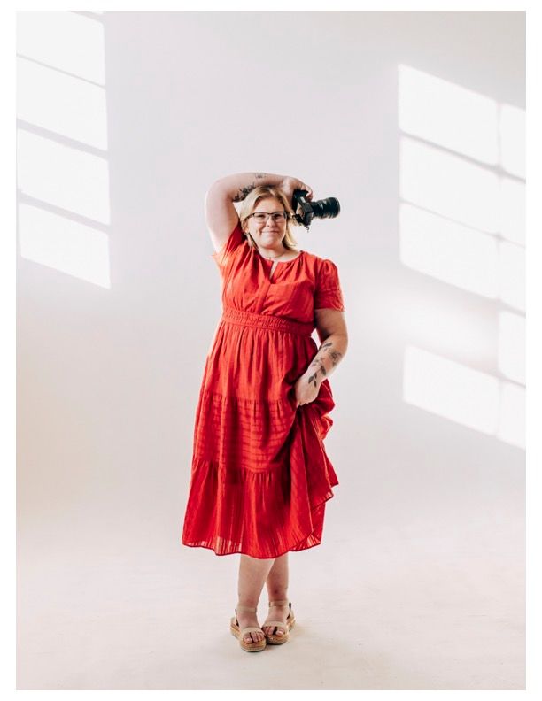 Woman in red tiered dress and glasses poses against white wall in three different angles showing summer fashion style.
