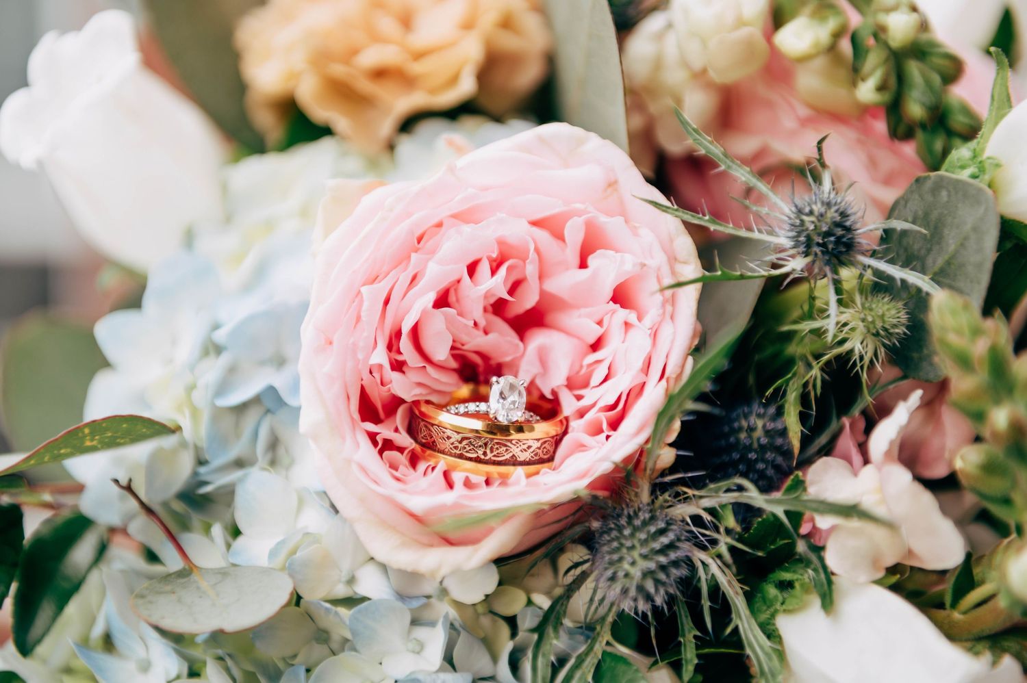 Elegant wedding floral arrangement featuring pink garden roses and eucalyptus.