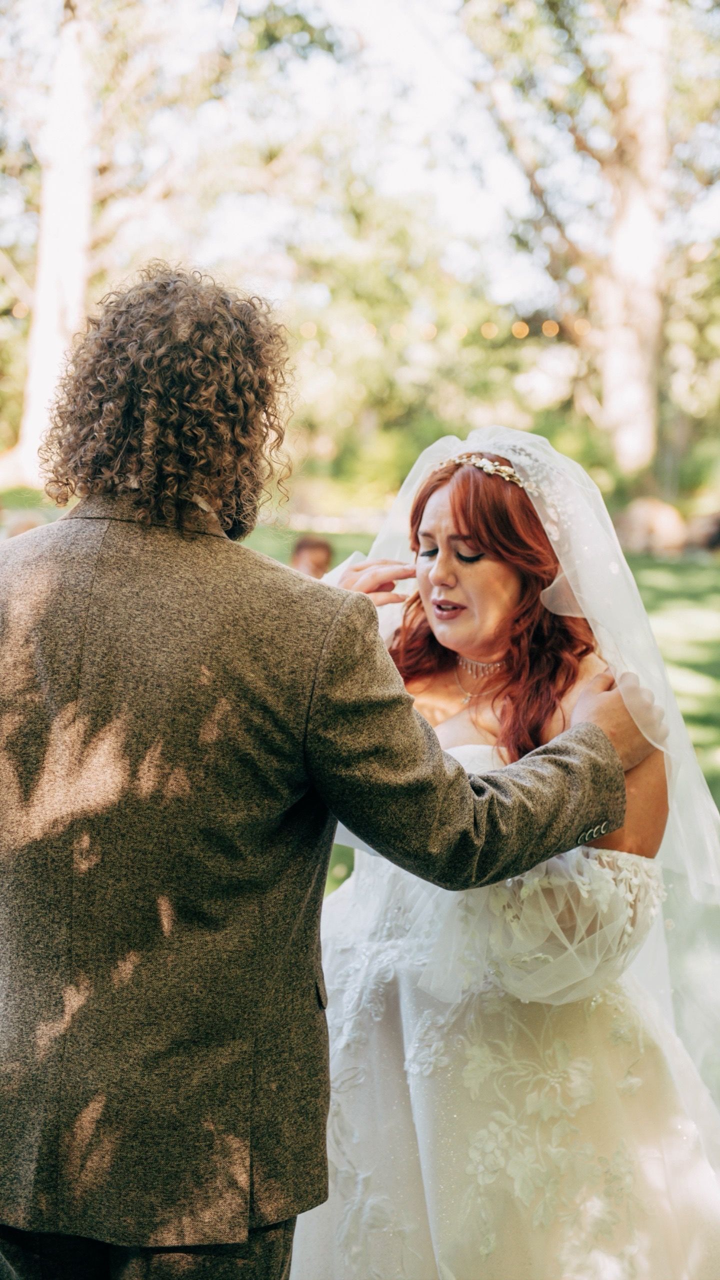 Wedding couple sharing playful dancing moments outdoors in natural lighting.