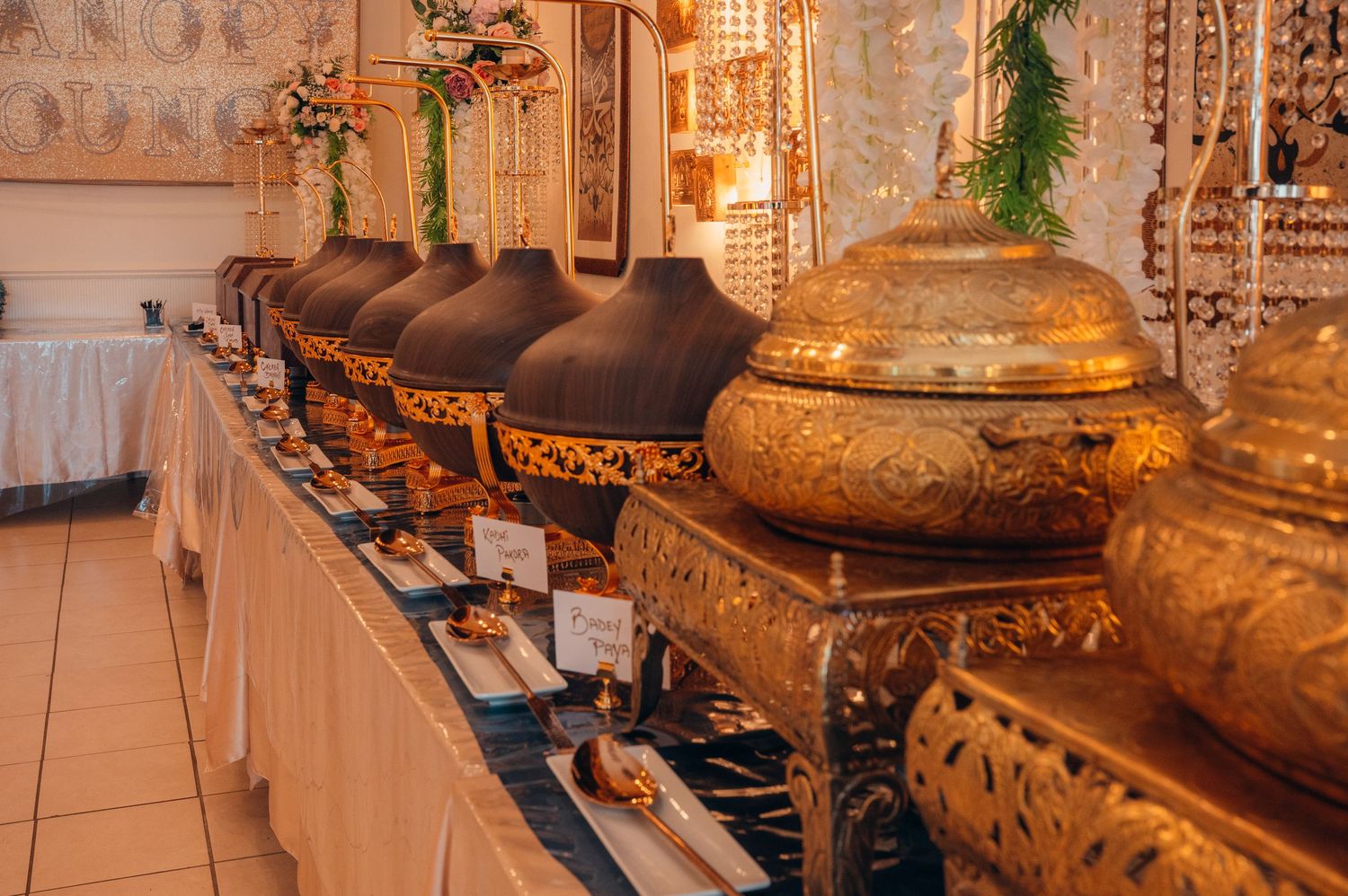 Elegant wedding reception buffet setup with ornate gold decorative elements.