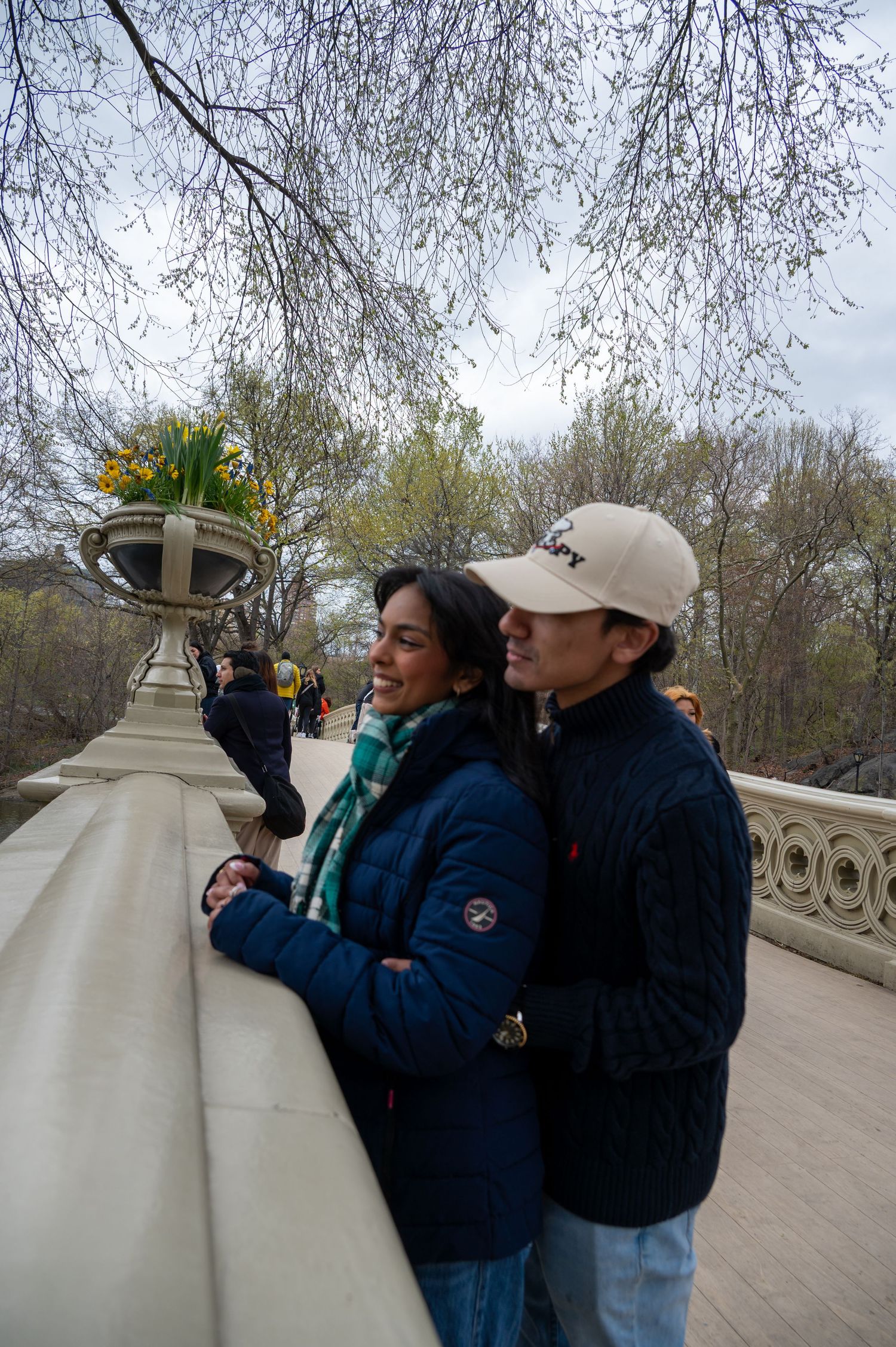 A couple enjoying a winter day together at a stone balcony overlooking Central Park.