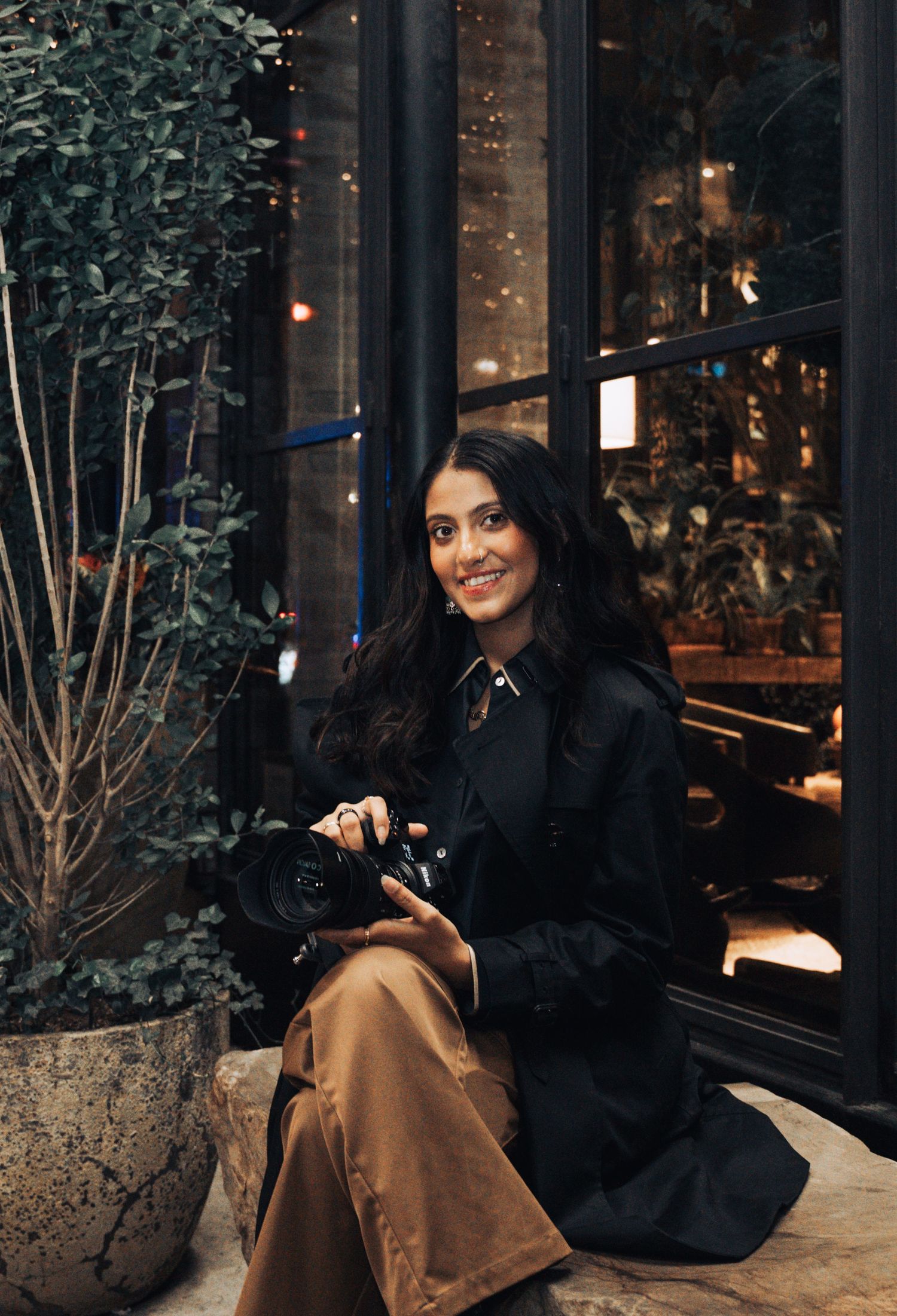 Evening portrait session outside a restaurant with warm ambient lighting.