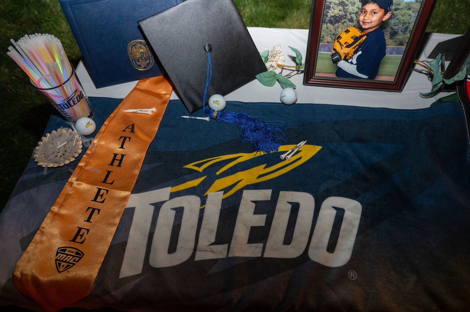 Graduation banners and pennants from various universities displayed together.