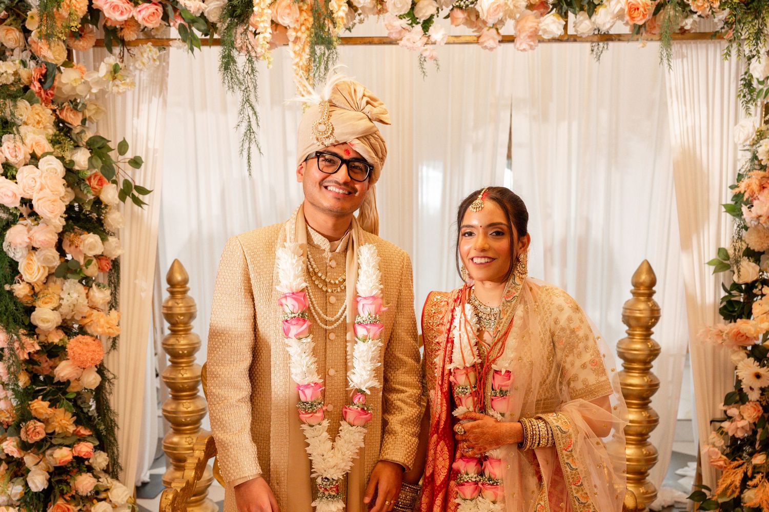 Traditional Indian wedding ceremony with decorative floral arrangements and soft lighting.