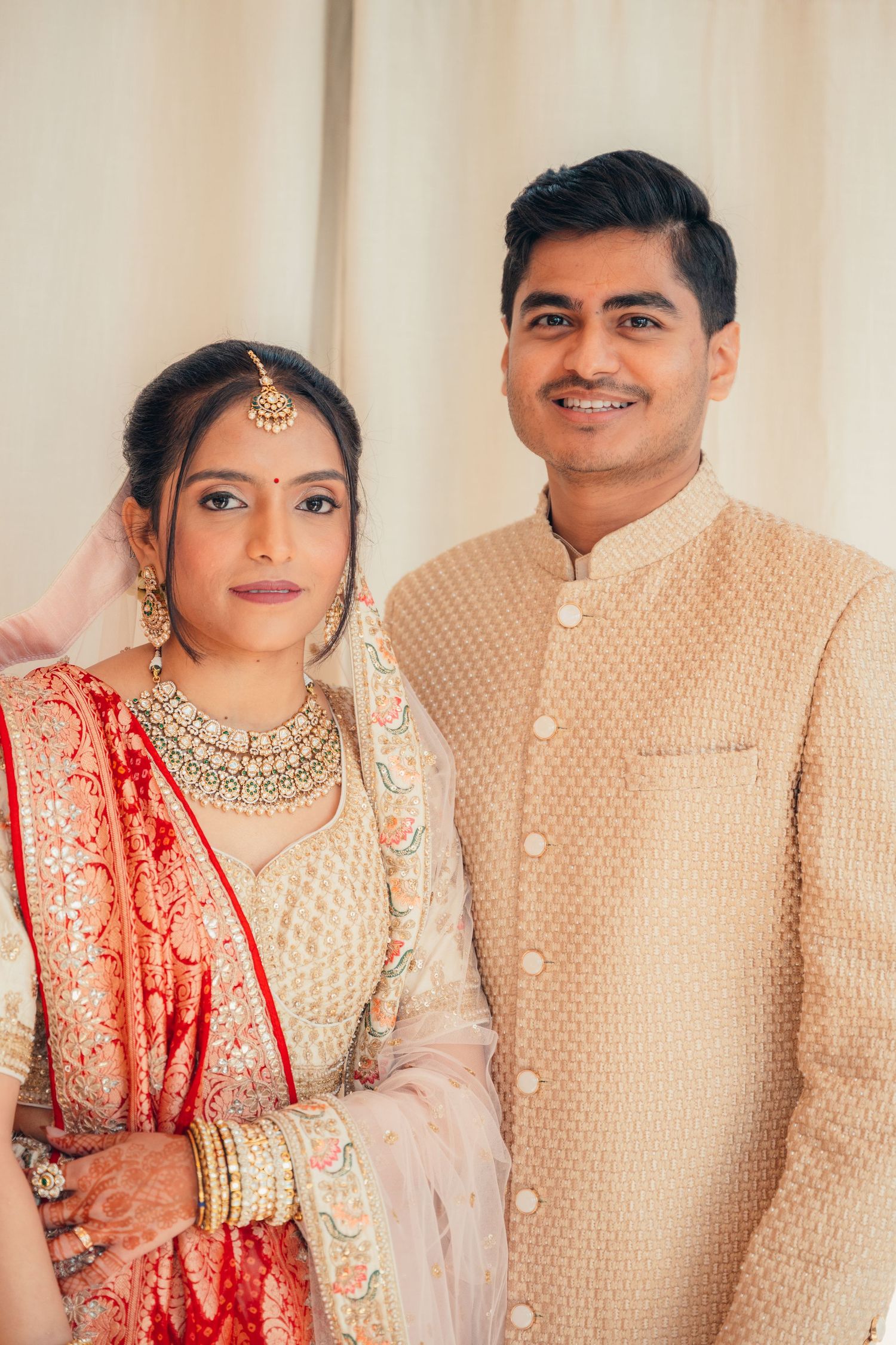 A couple in traditional Indian wedding attire poses together in a series of close-up shots.