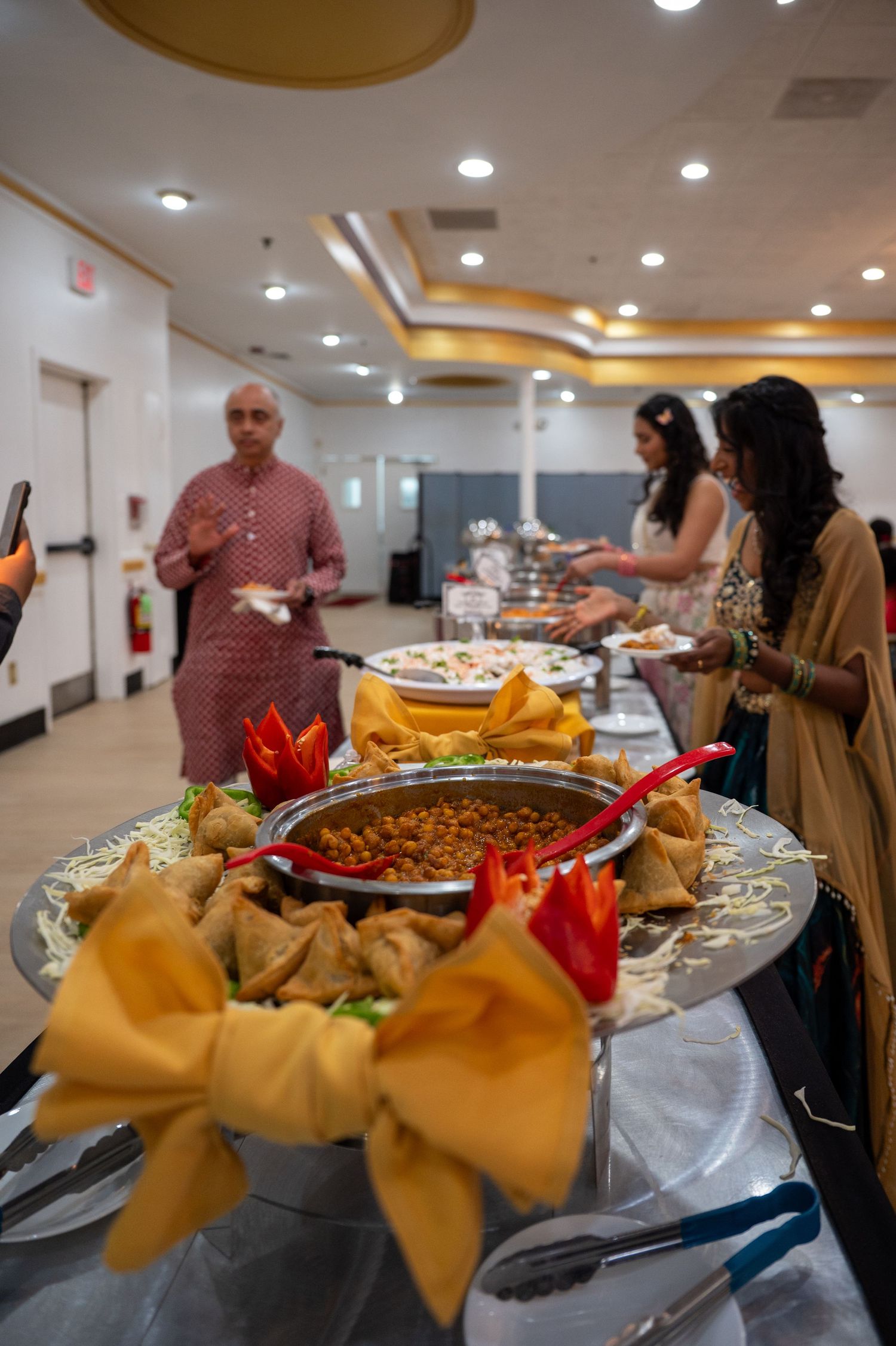 Buffet table with various dishes and appetizers at graduation celebration.