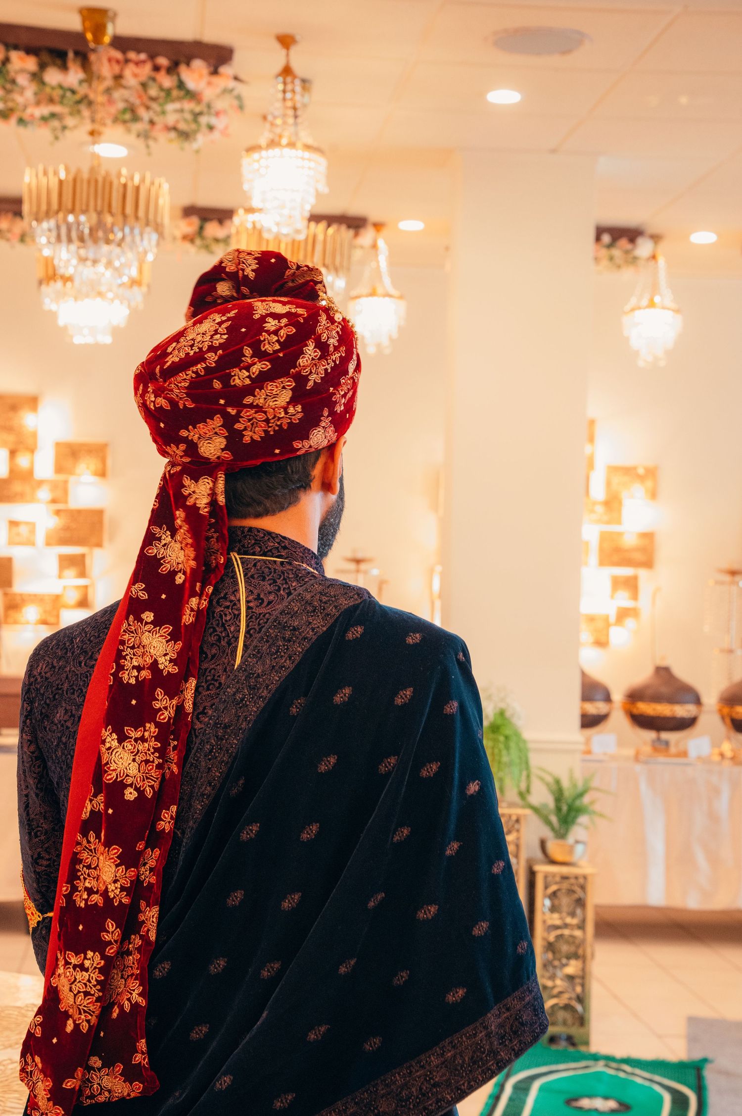 Traditional South Asian formal wear with velvet and embroidered details in bright venue.