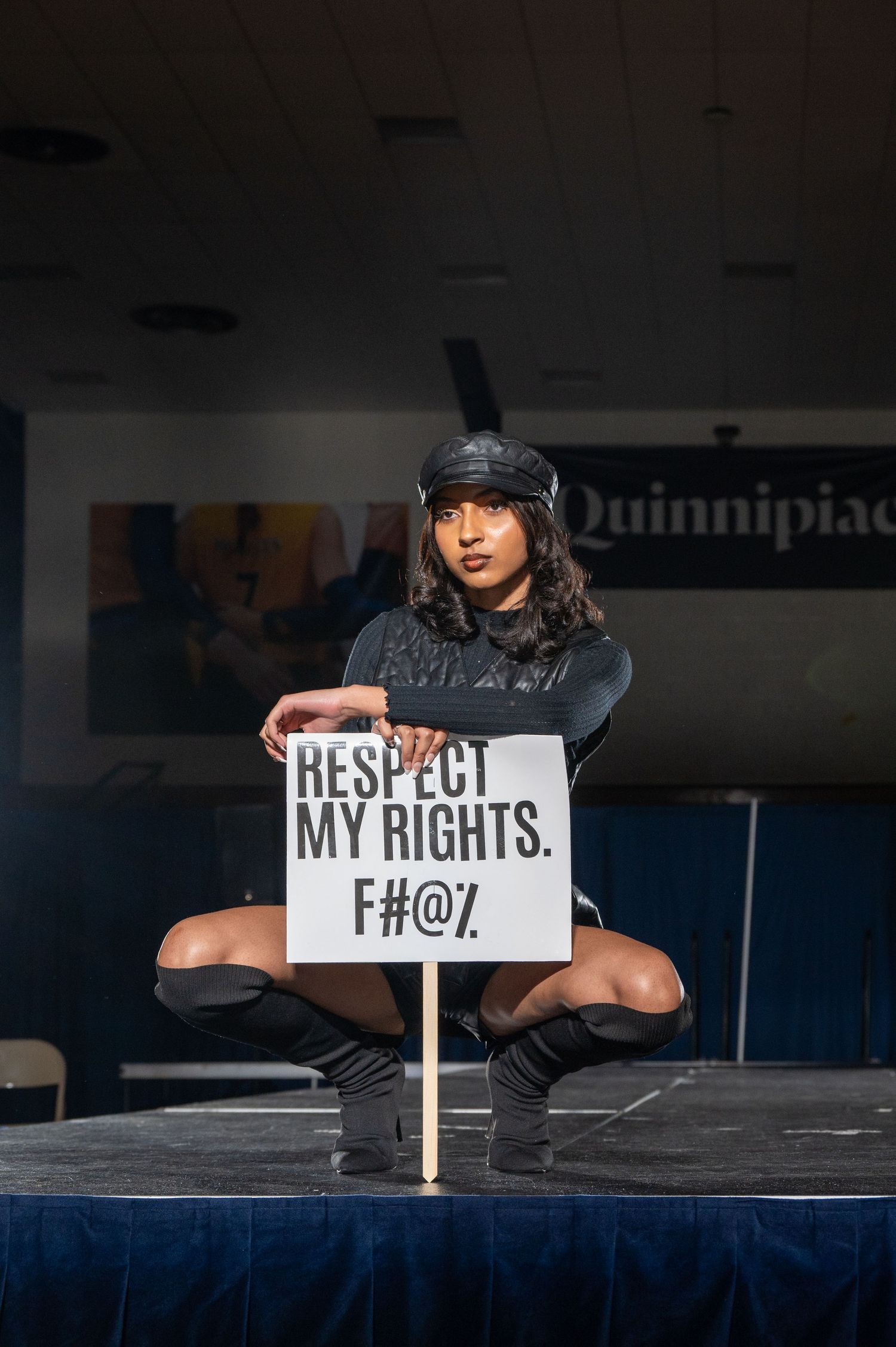 Protesters display signs about rights and respect during a staged performance.