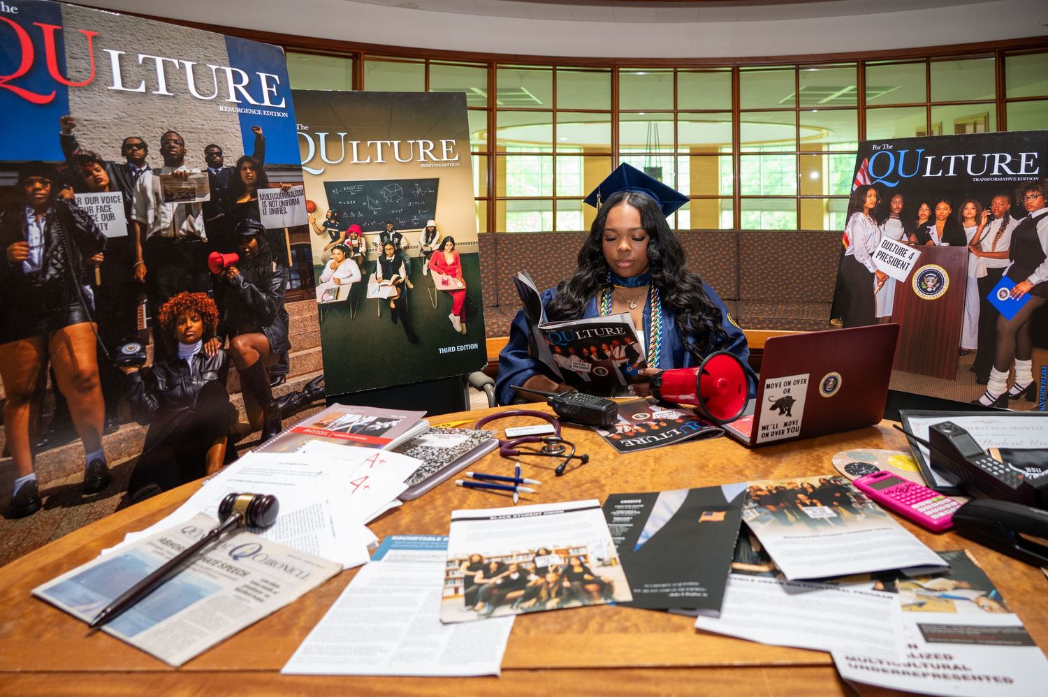 Students studying and collaborating at tables in a modern university library setting.