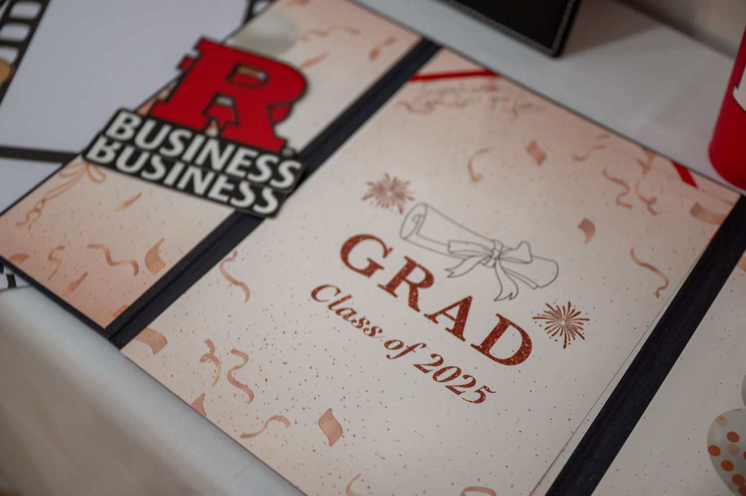 Close-up of graduation celebration cards and invitations laid out on a surface.