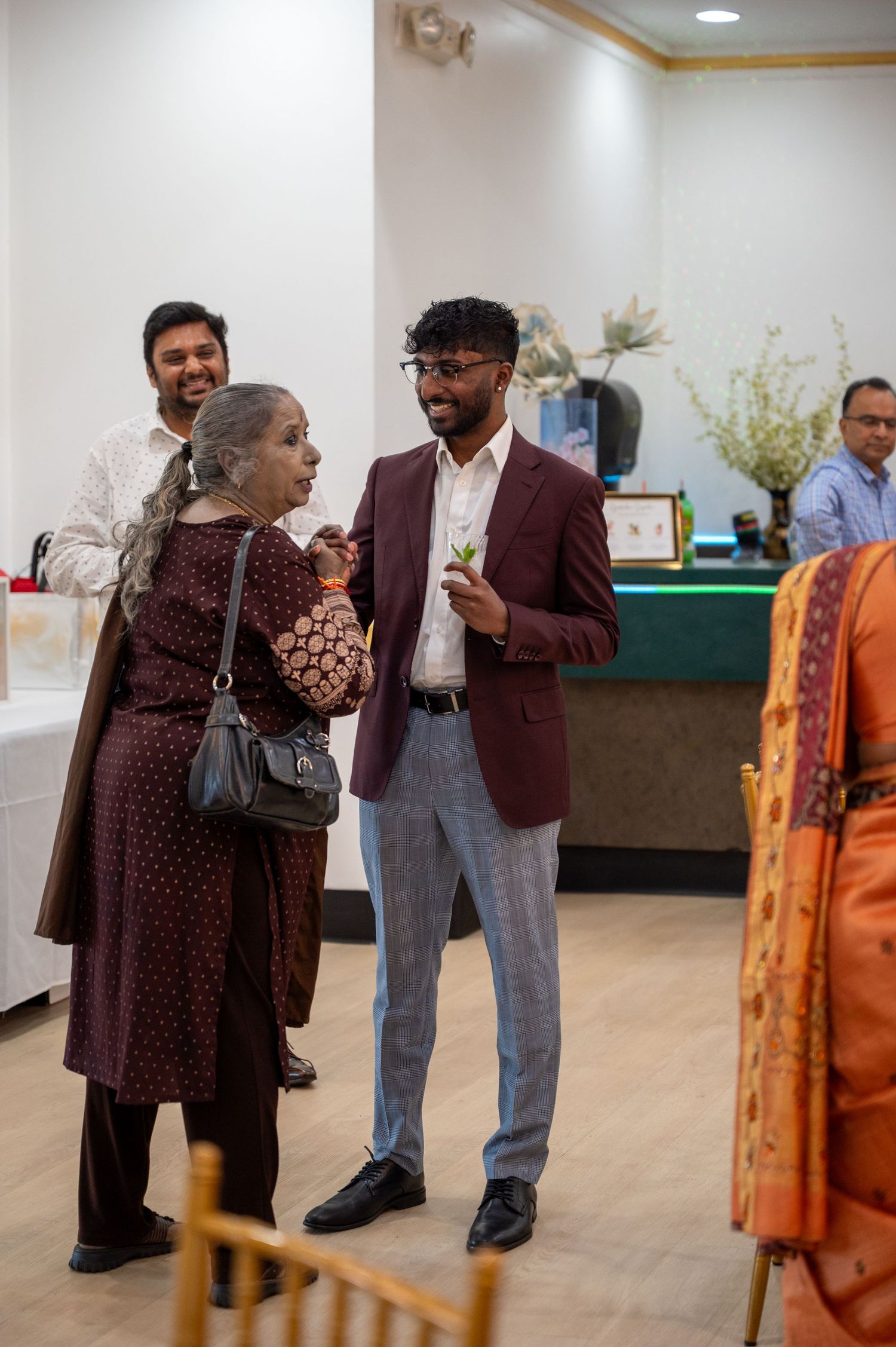 Guests mingling at an indoor graduation celebration event.