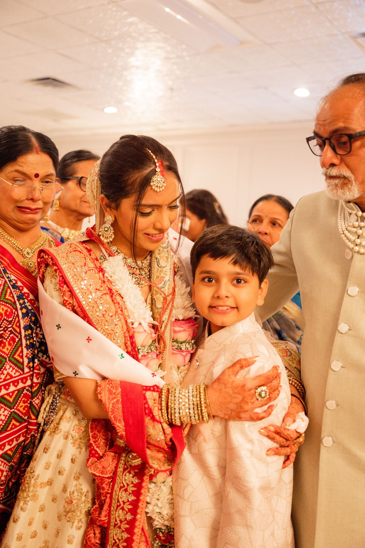 Family members in traditional Indian wedding attire gathered for a group photo.
