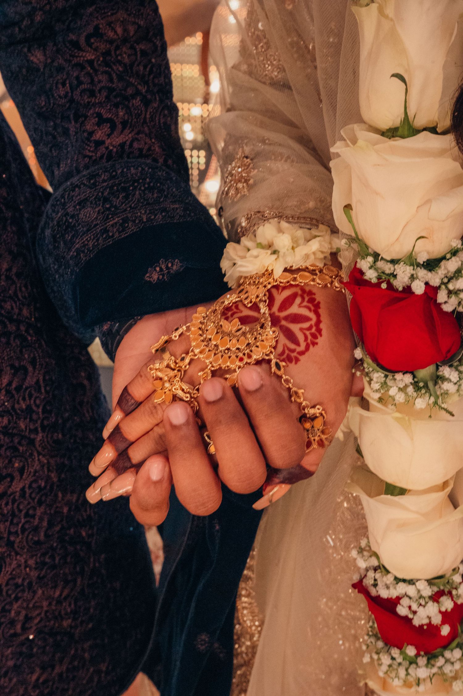 Close-up shots of hands adorned with traditional Indian wedding jewelry and henna during a wedding ceremony.