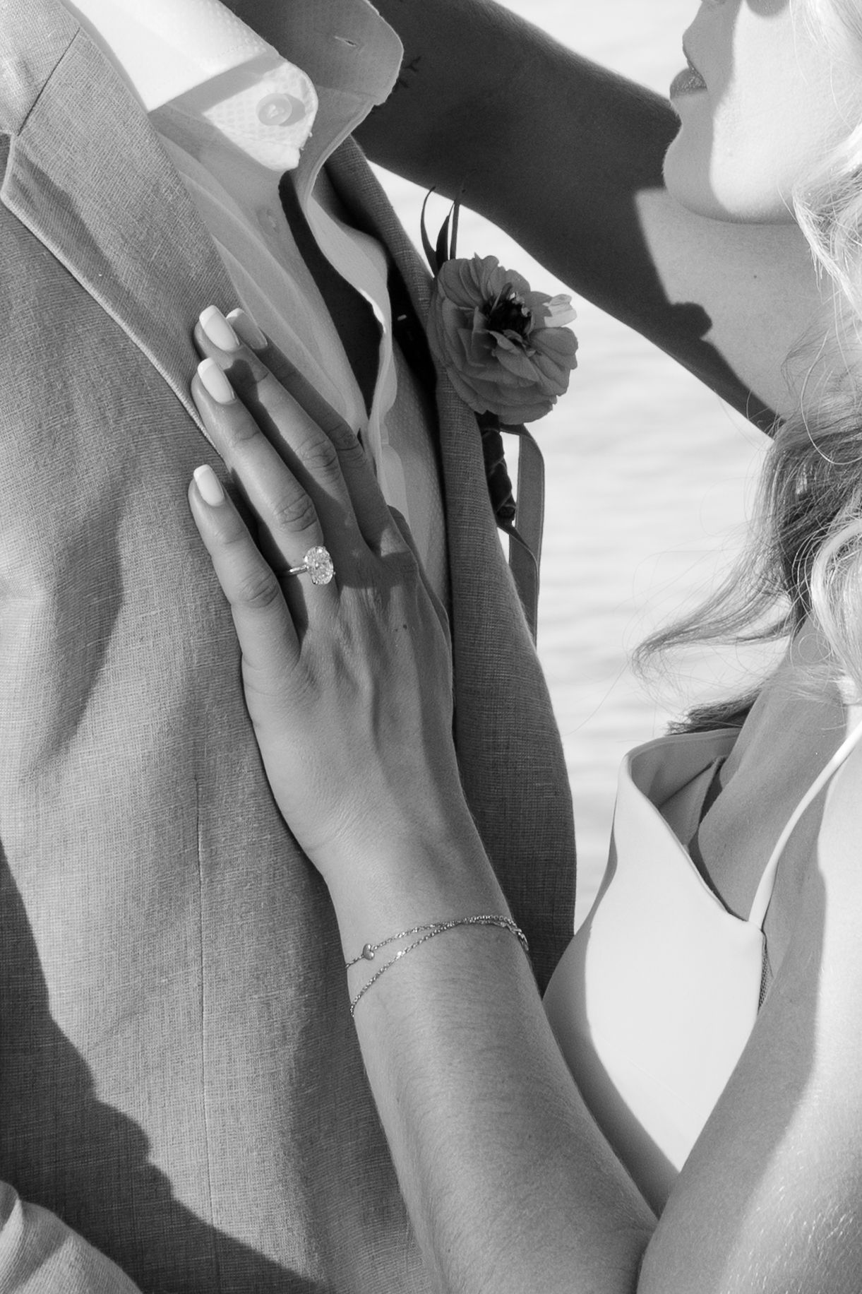Close-up shots of hands touching in intimate wedding moments.