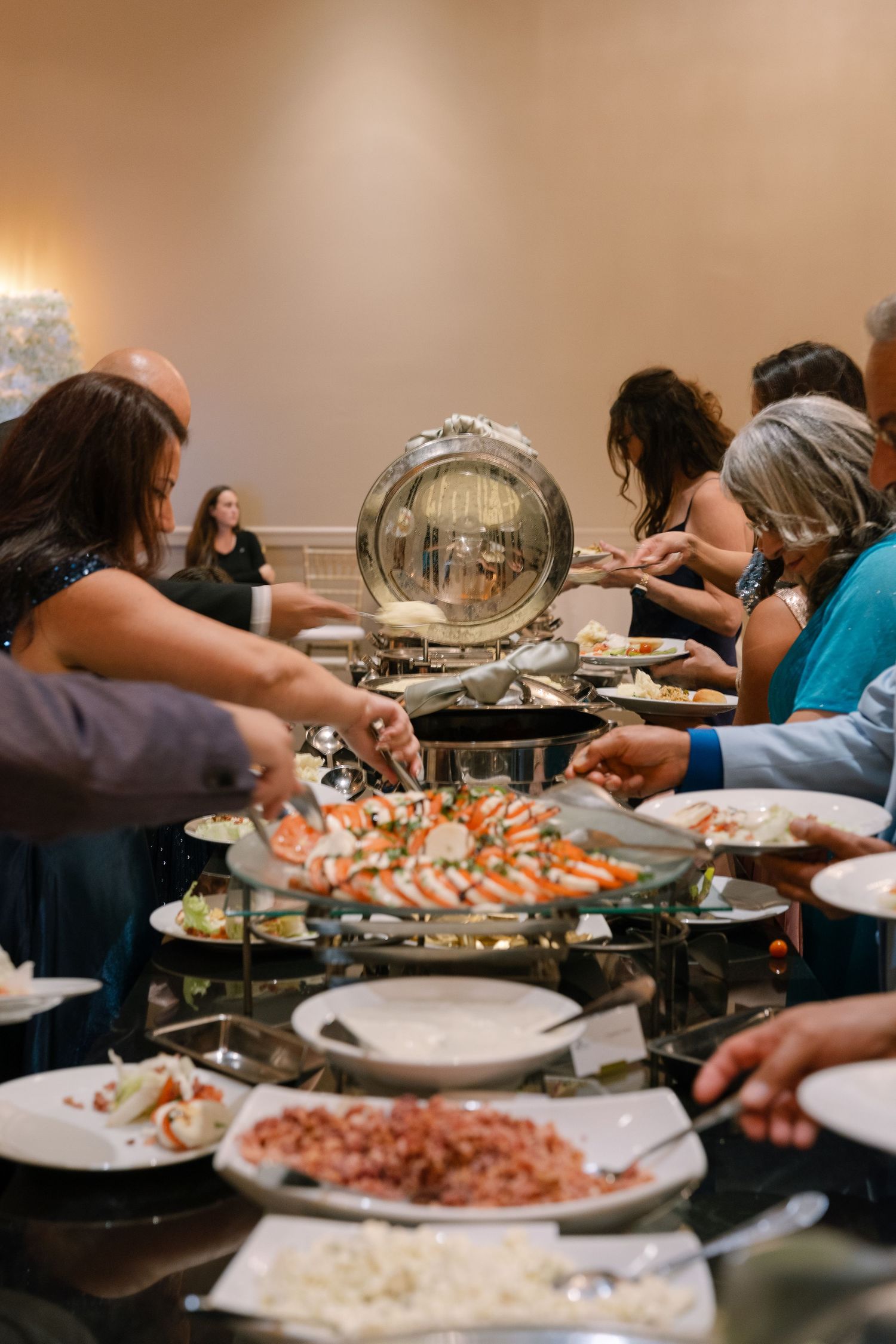 Buffet table spread with various dishes and platters at a catered event.