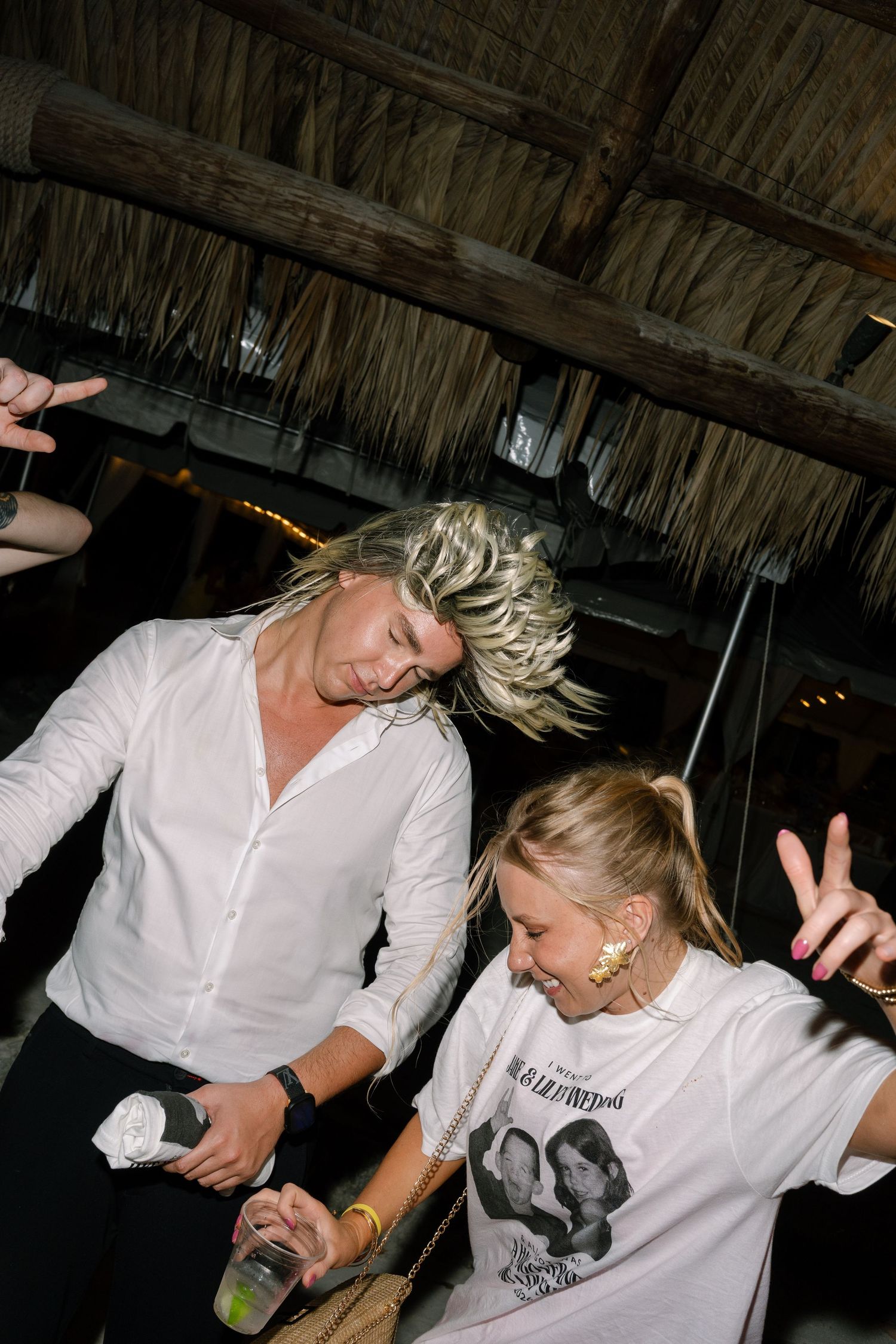 Two people dancing and enjoying themselves at a lively music event.