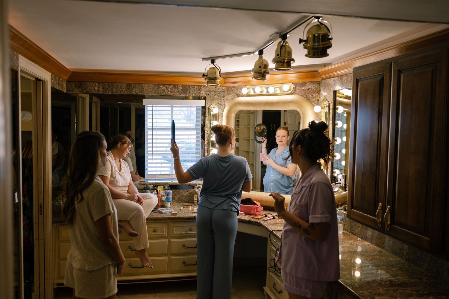 A group of people gathered in a cozy kitchen, preparing food and interacting with each other.