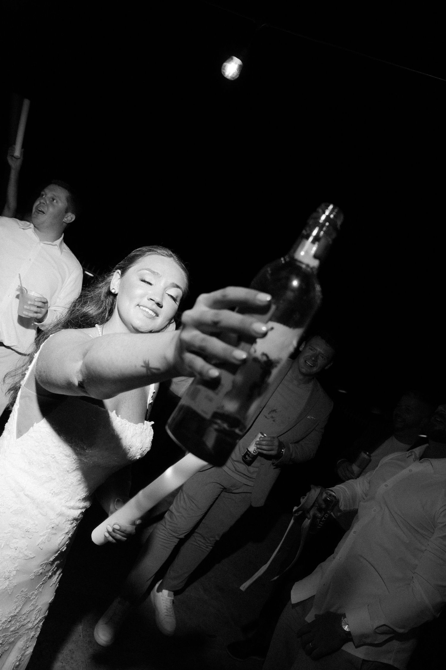 A sequence of black and white photos showing people dancing and celebrating at a party.